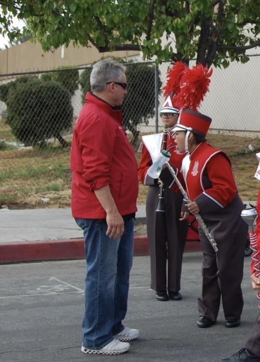 A man in red jacket and red hat standing next to a group of people