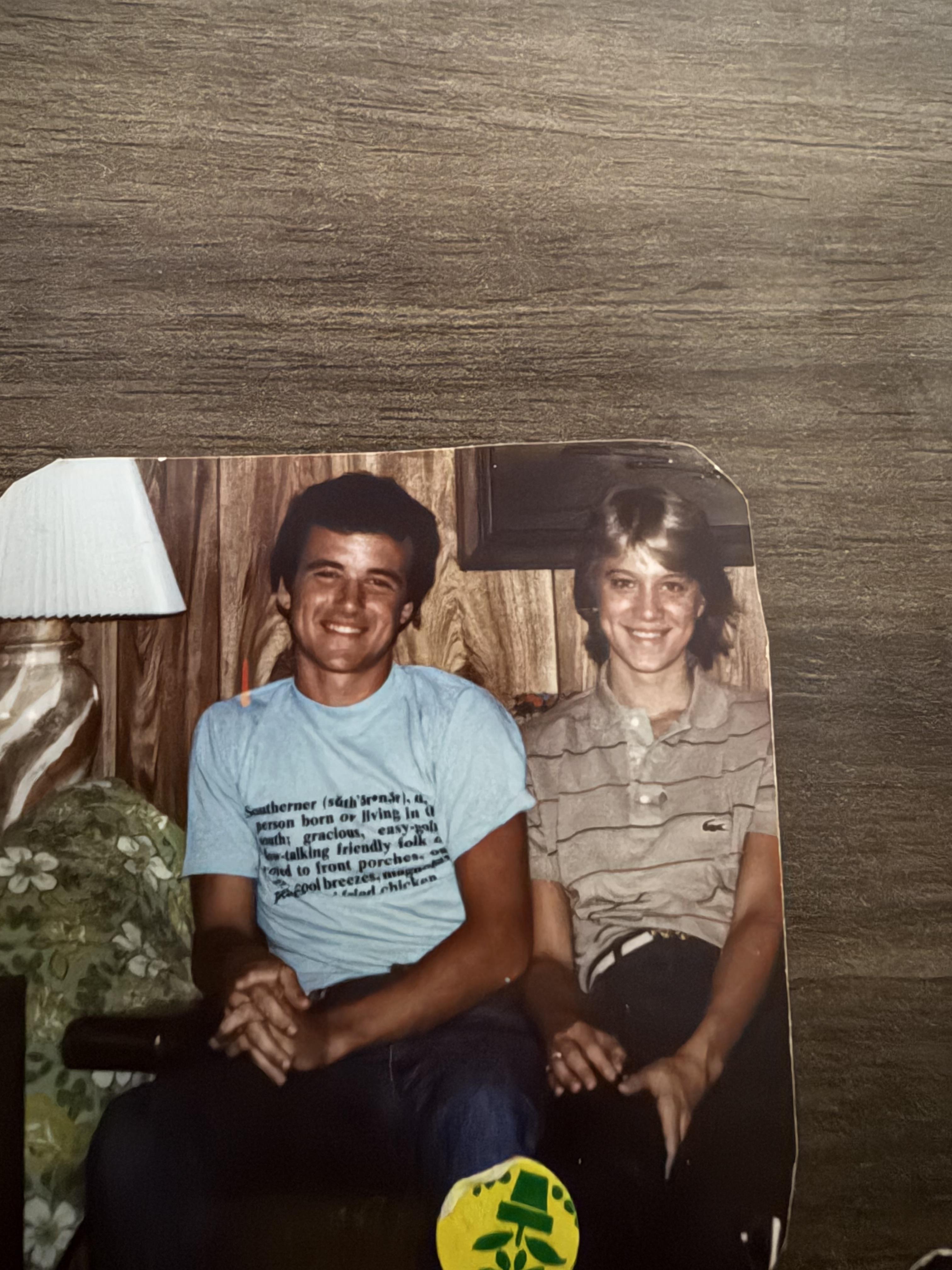 A man and woman sitting on a chair