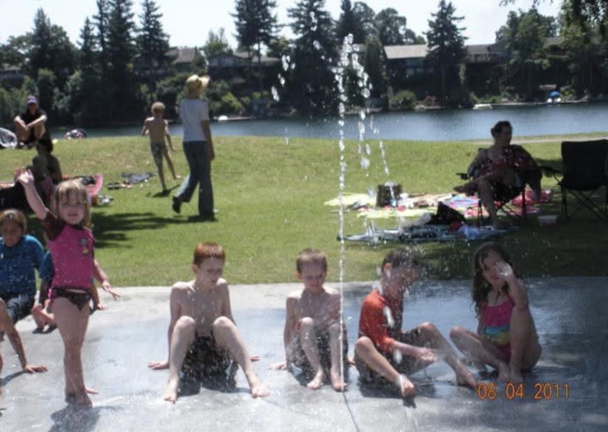 A group of people playing in a fountain