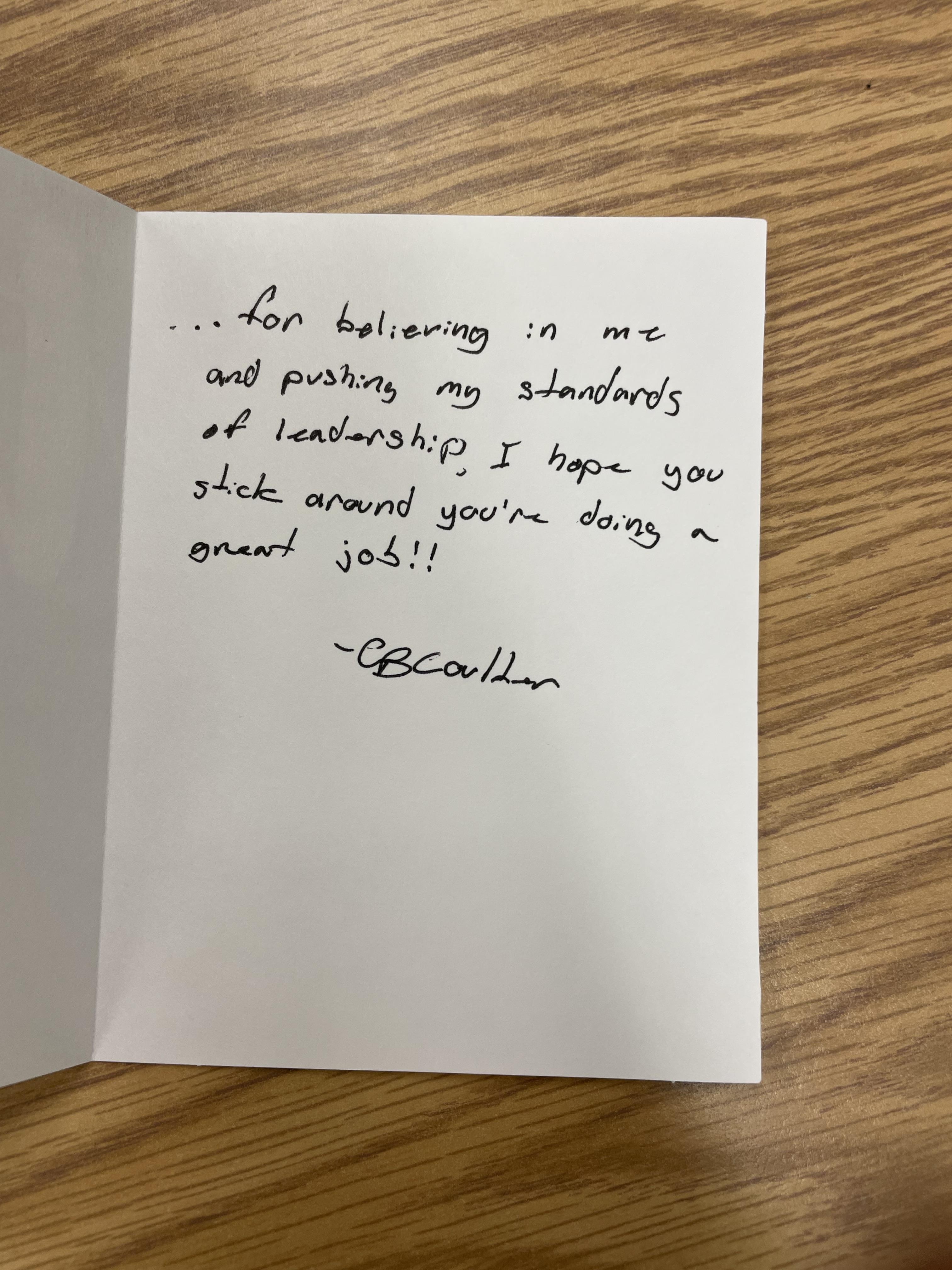 A white card with black writing on it