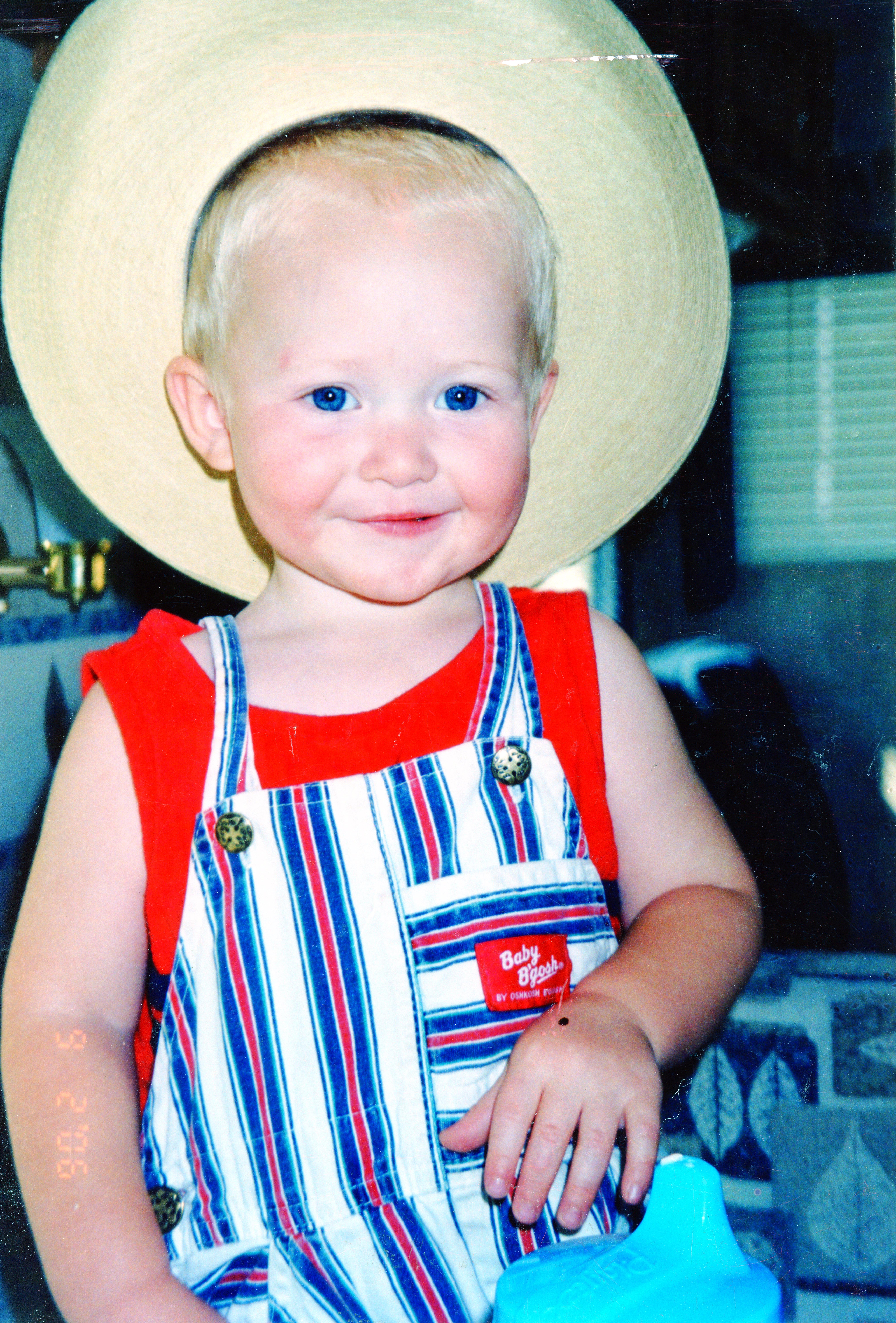 A baby wearing a straw hat