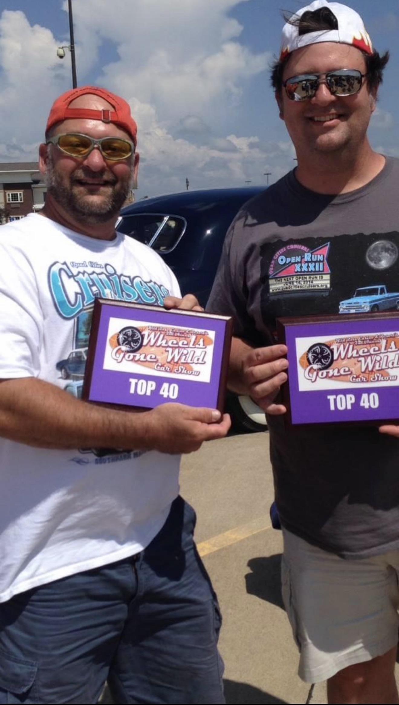 A pair of men holding up a purple and white rectangular box