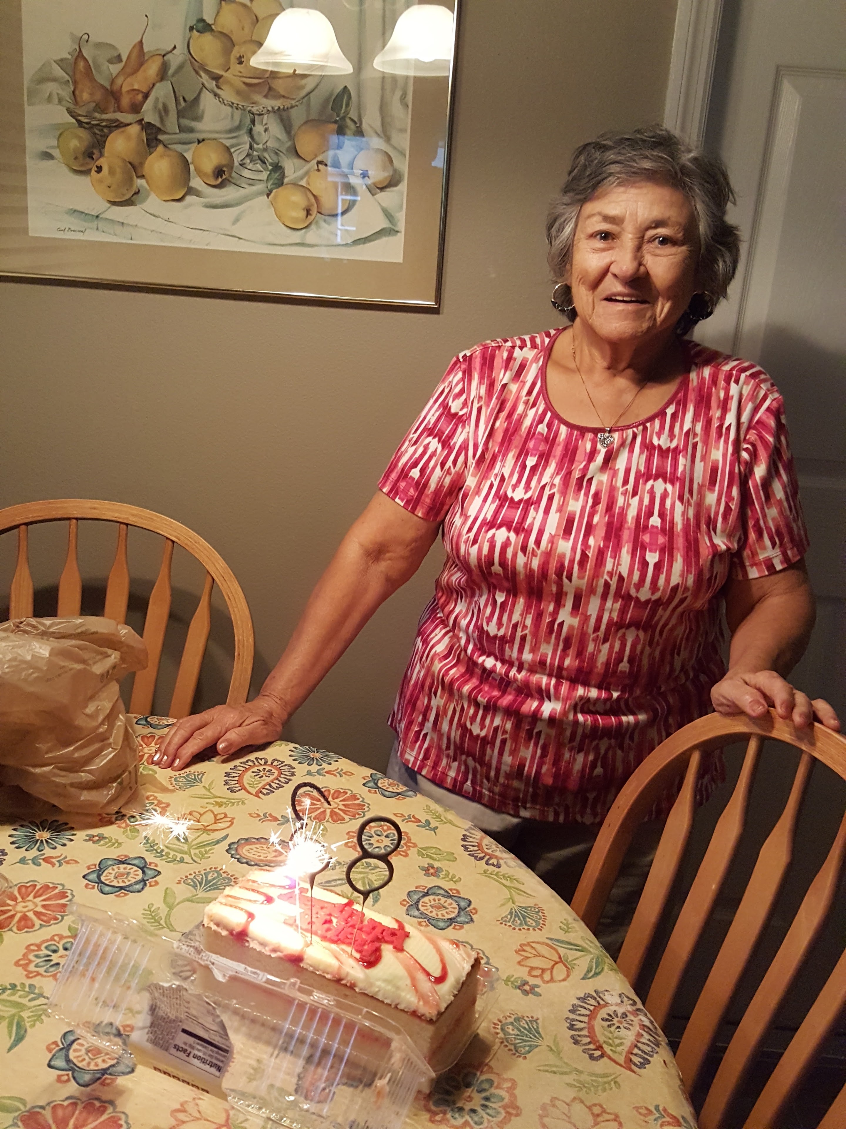 A woman standing at a table with a cake