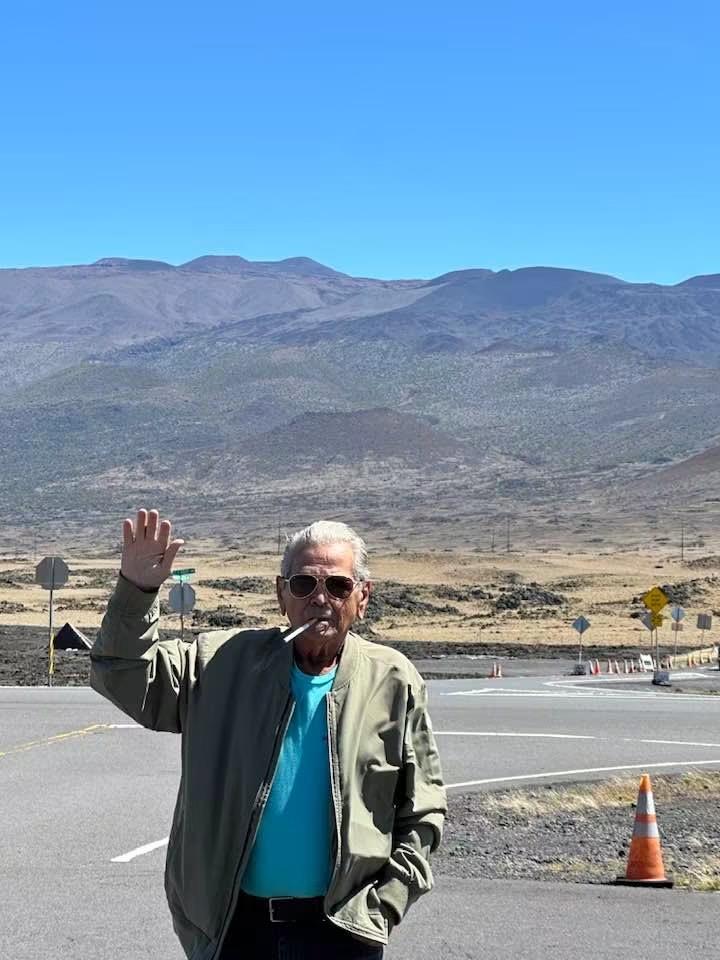 A man smoking a cigarette in front of a road