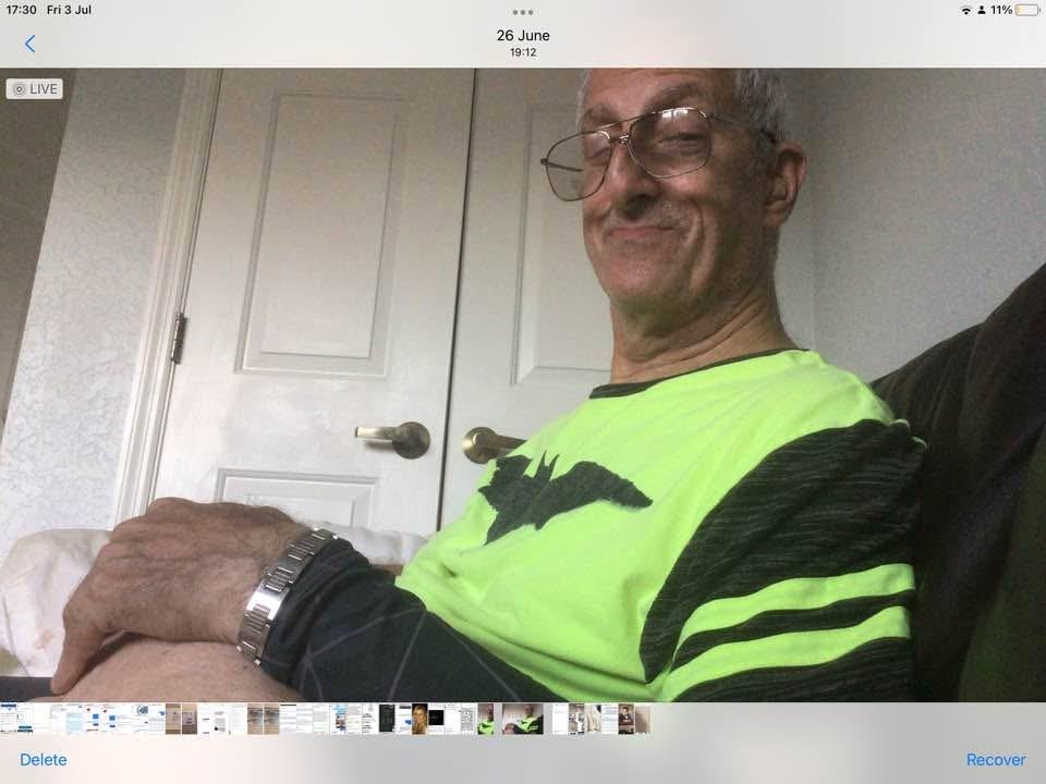 A man wearing glasses and a green shirt