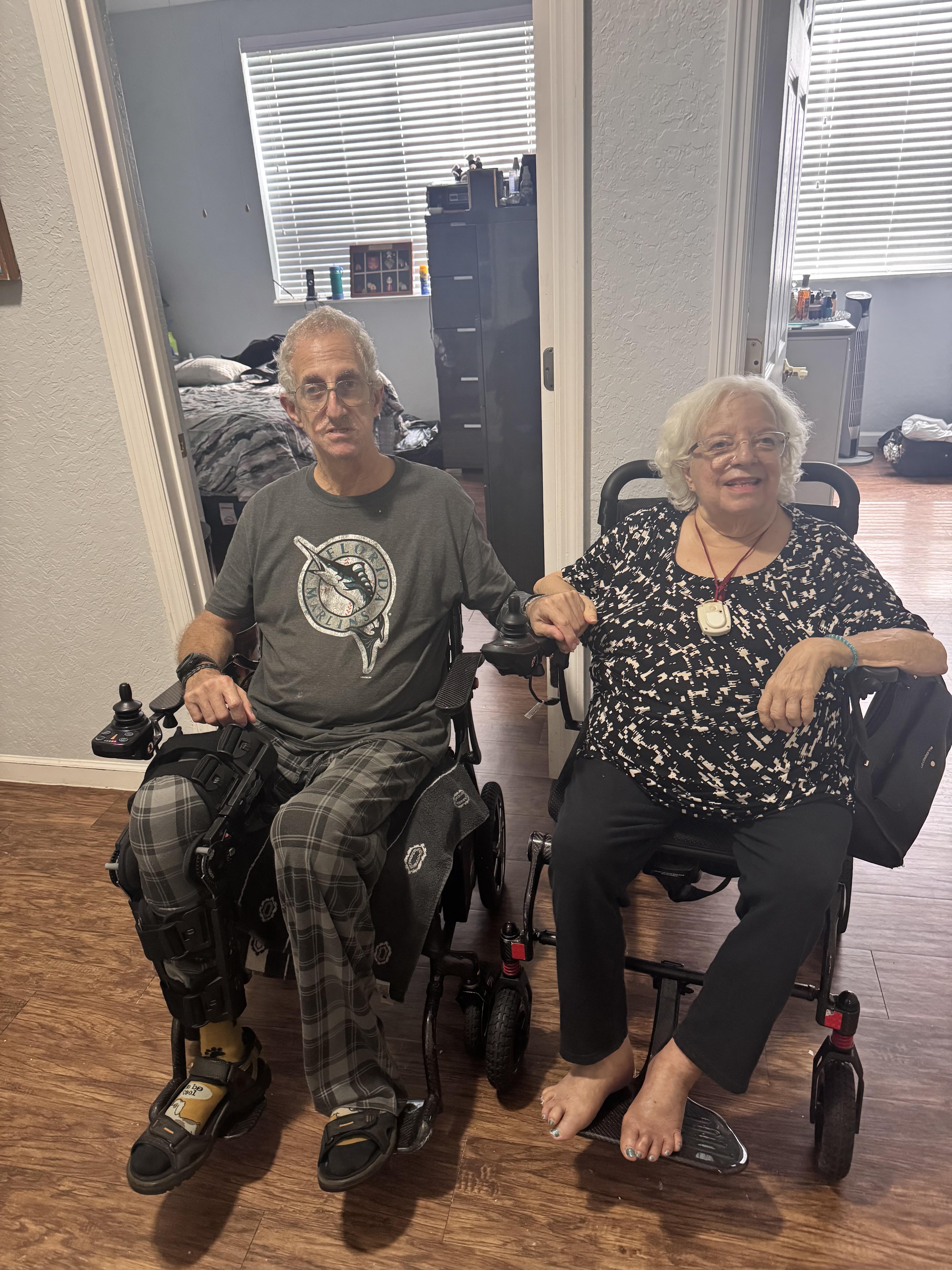 A man and woman sitting in wheelchairs