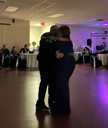 A man and woman kissing in a room