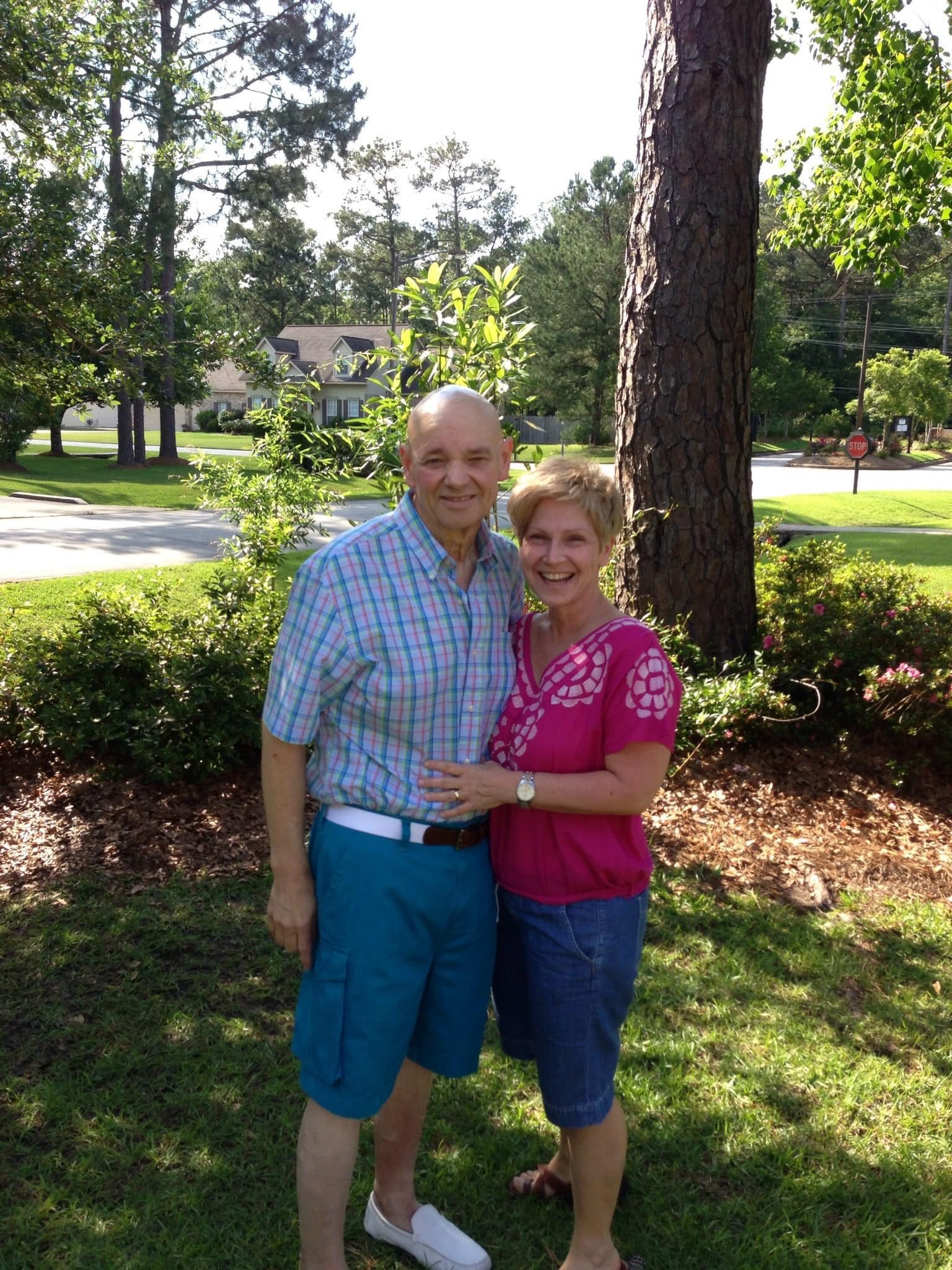 A man and woman standing together in a park