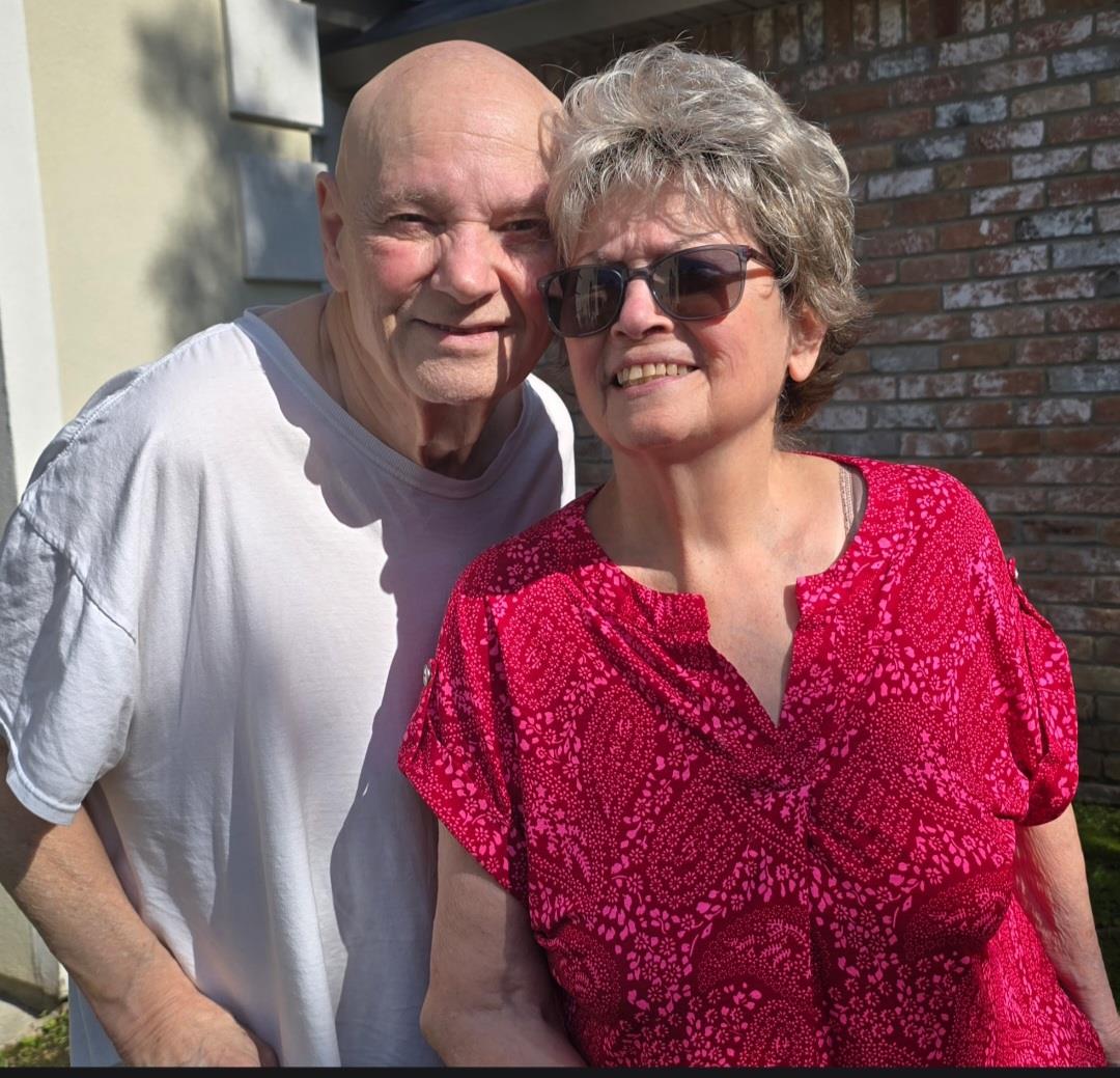 A man and woman standing together outside