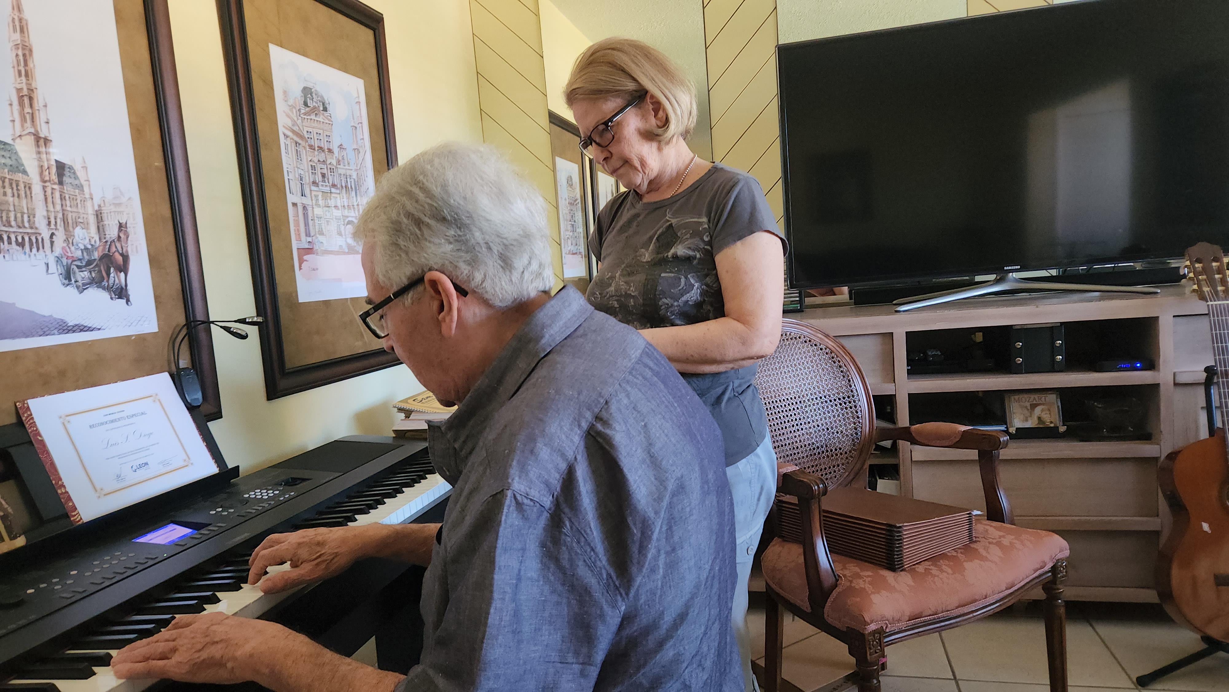 A man and woman playing piano