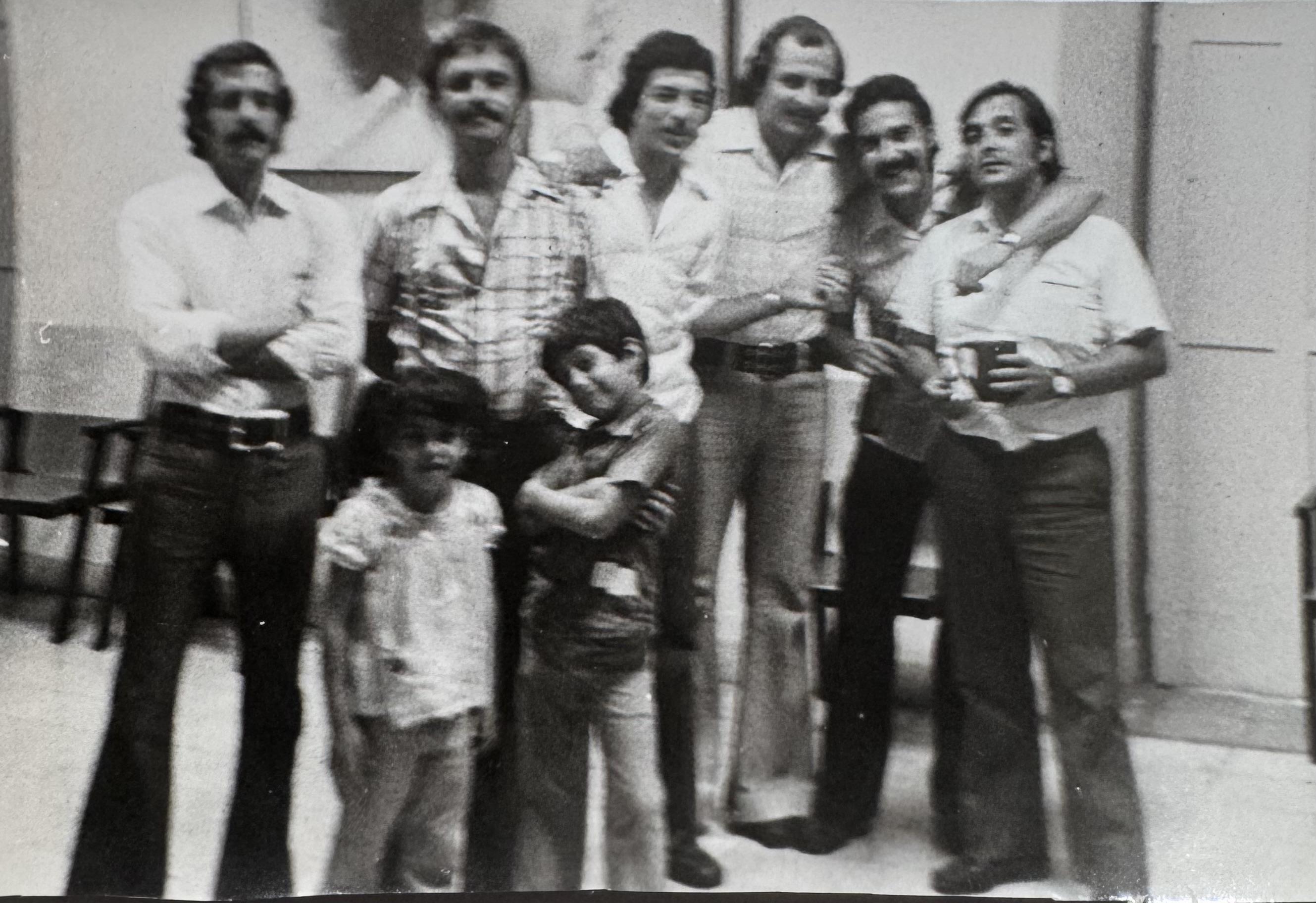 A group of men and children posing for a photo