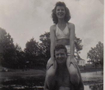 A woman sitting on a man's shoulders