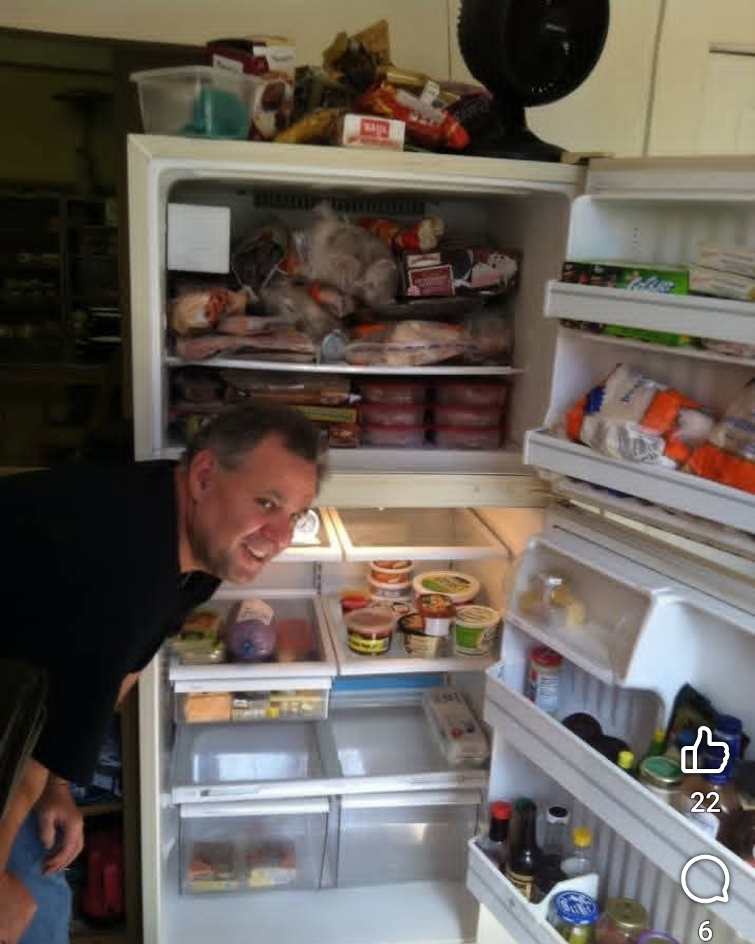 A man standing in front of a refrigerator