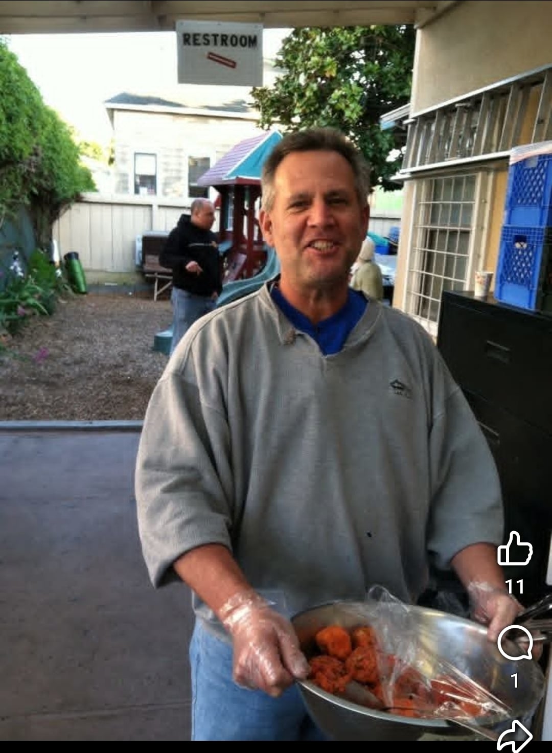 A man holding a bowl of carrots