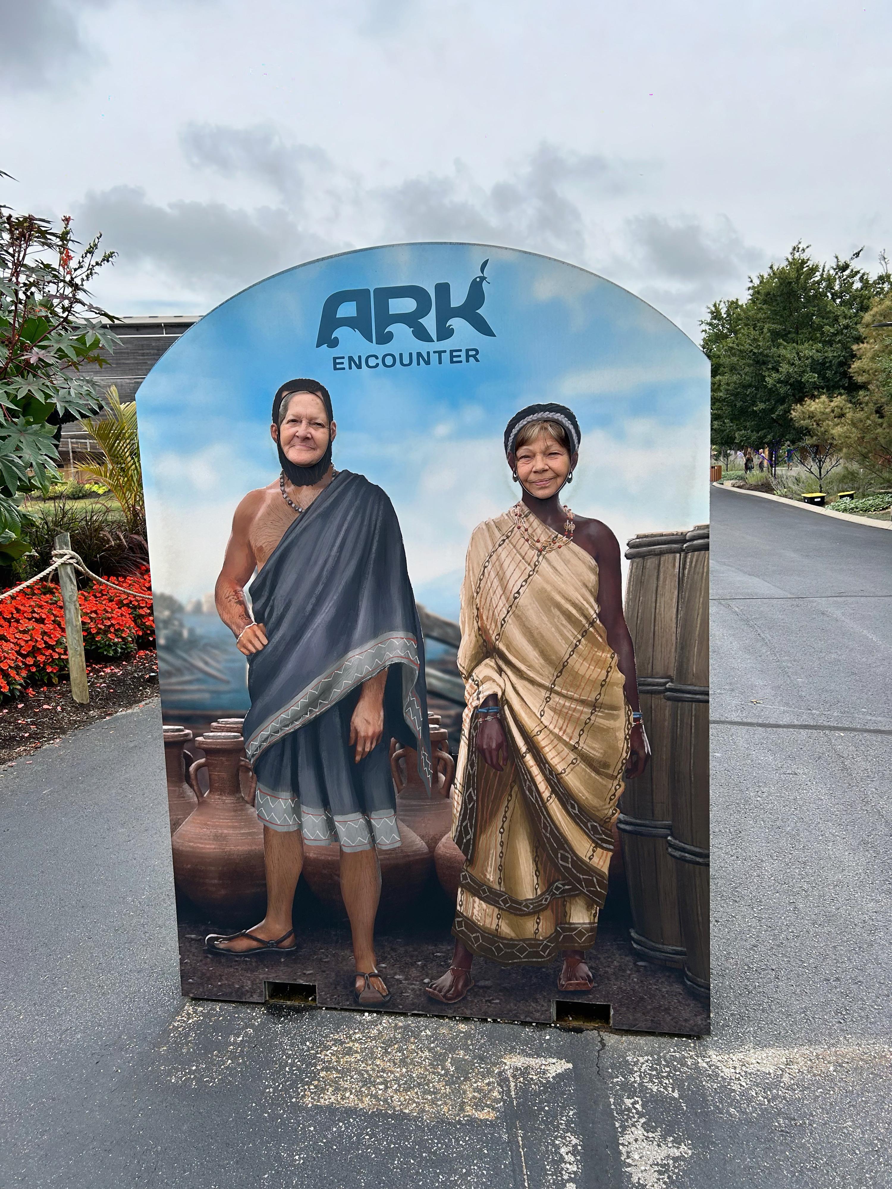 A sign with a couple of people in traditional clothing