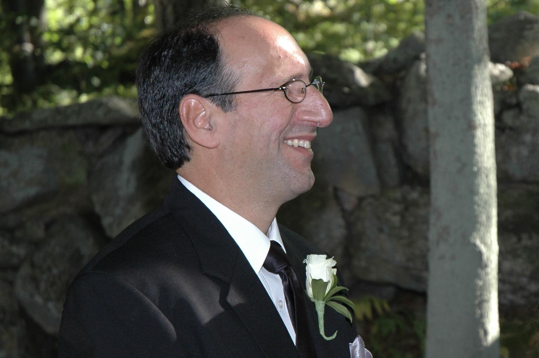 A man in a suit smiling