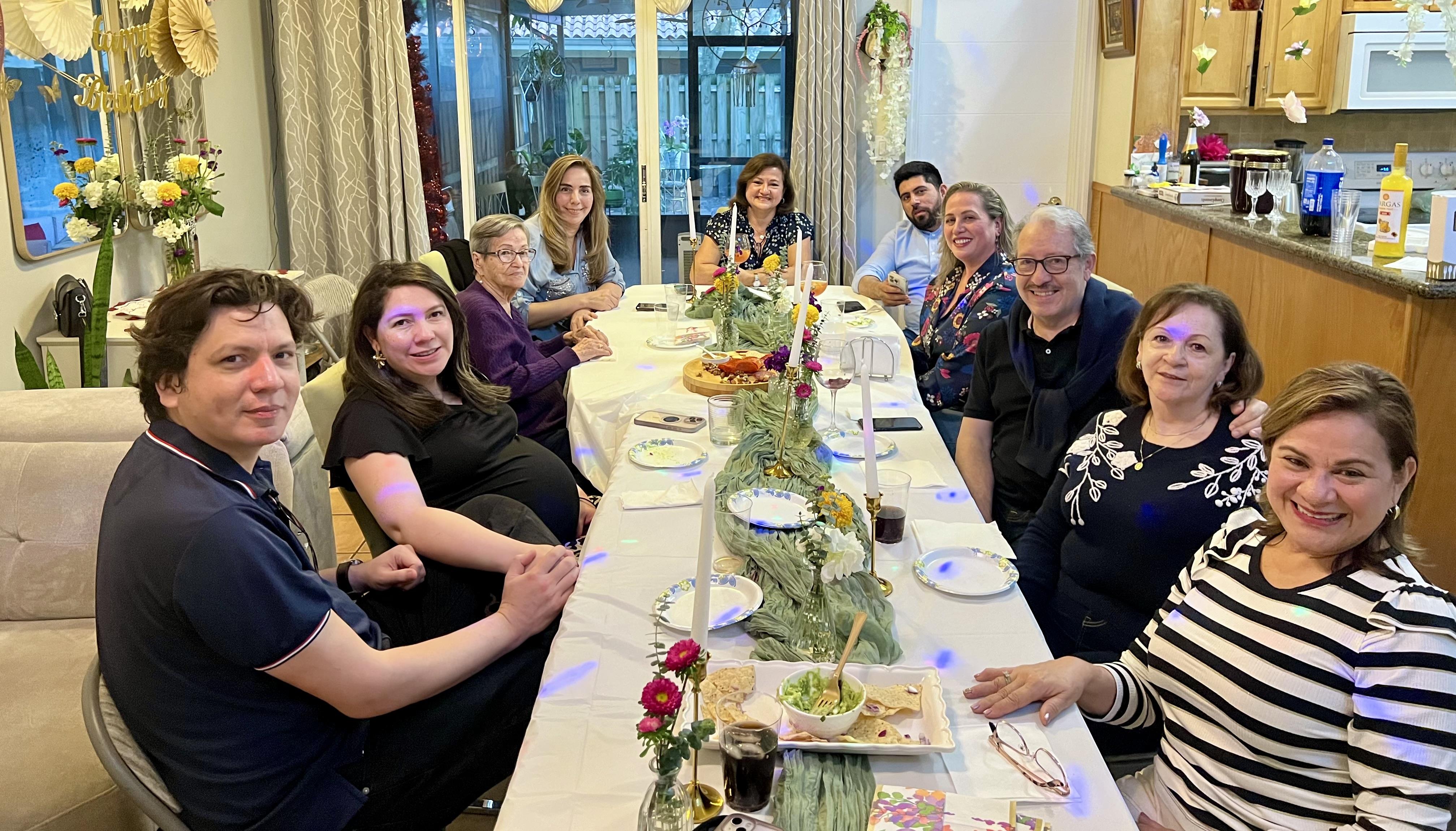 A group of people sitting around a long table