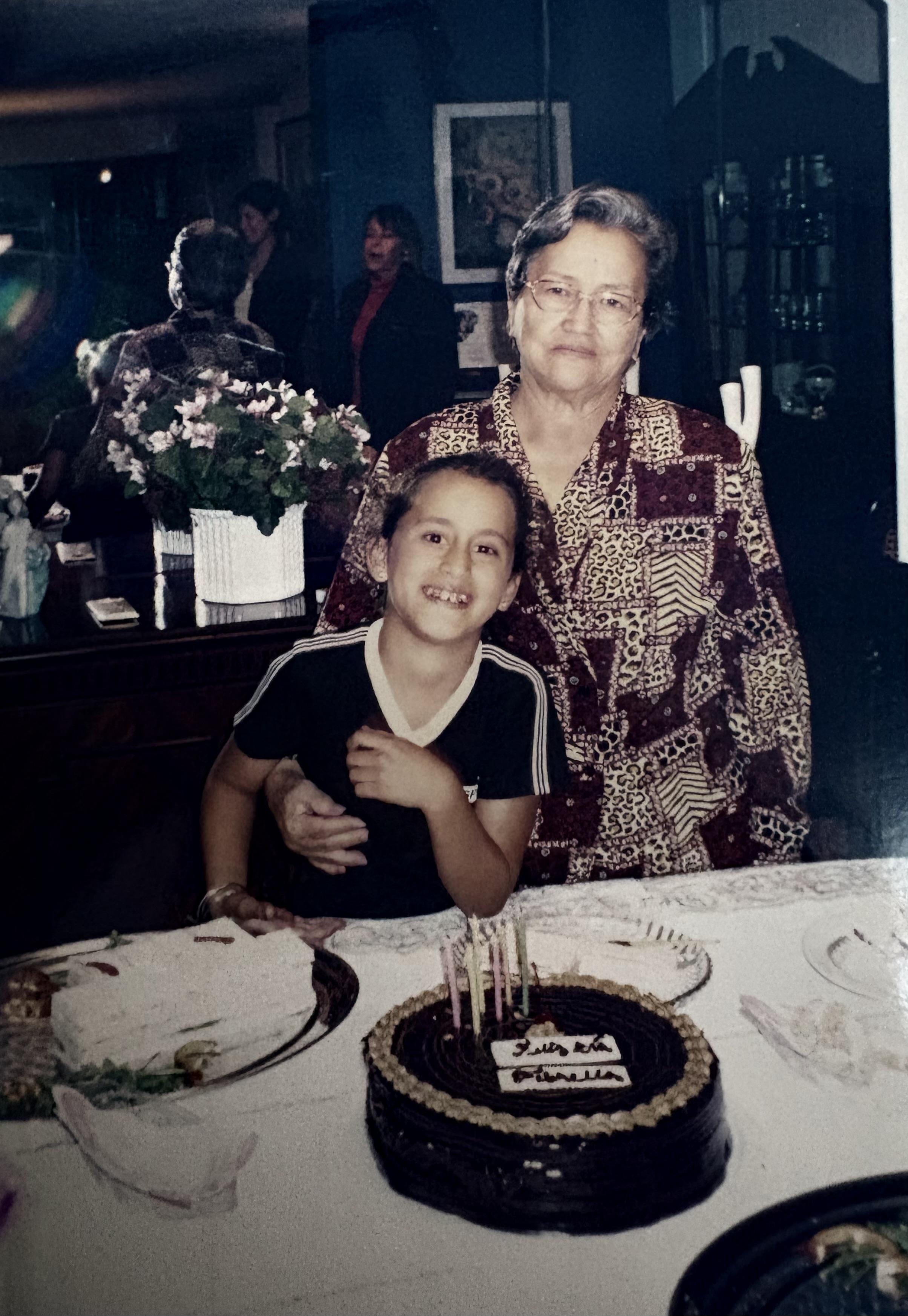 A woman and a boy posing for a picture