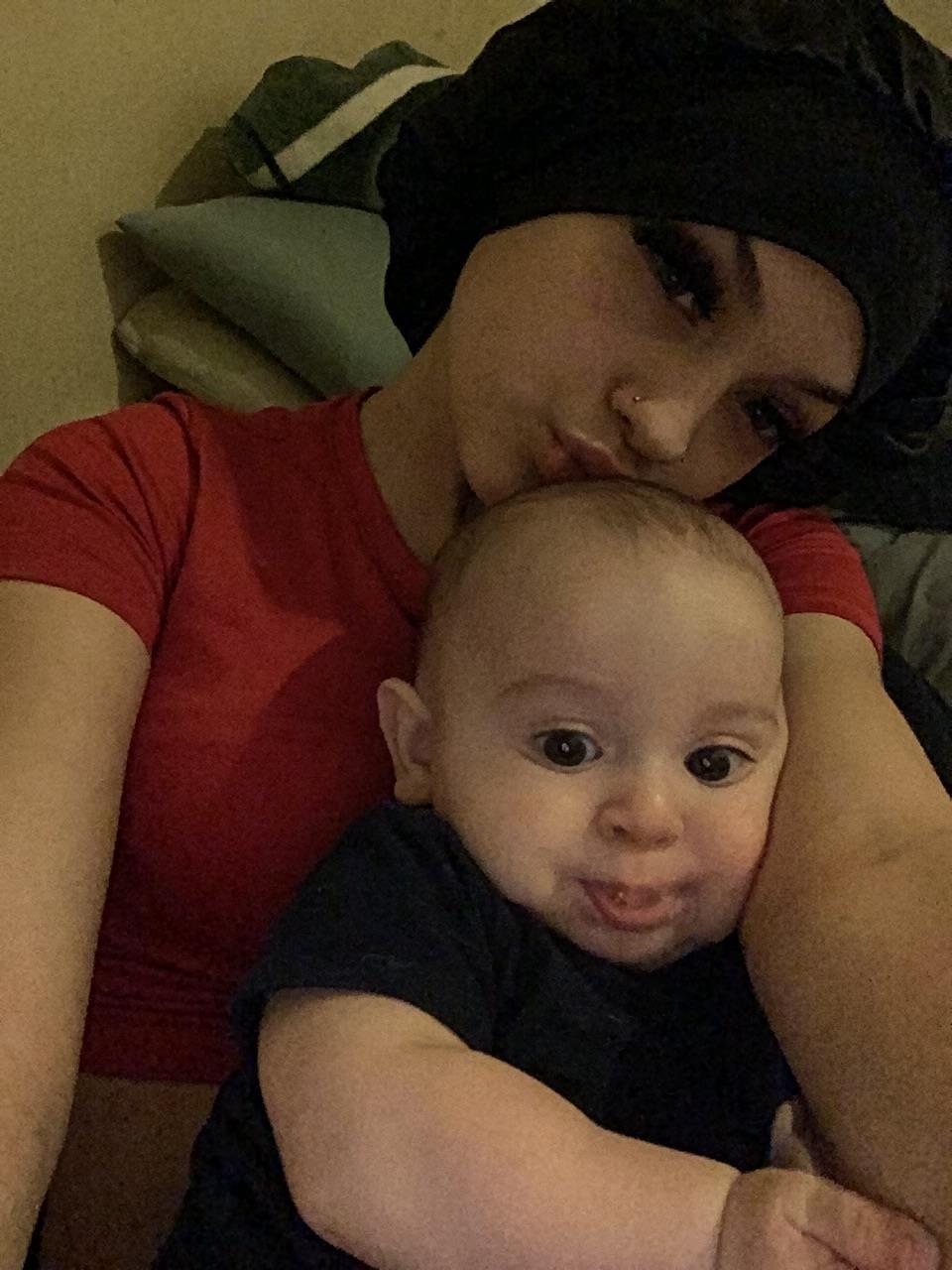 A woman taking a selfie with a baby