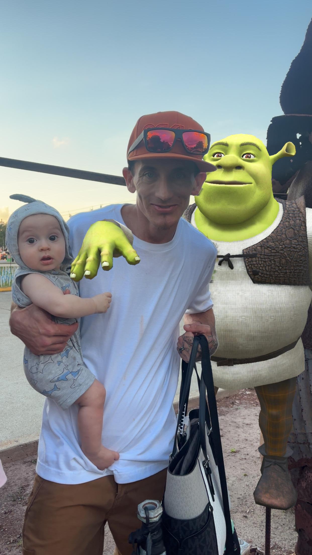 A man holding a baby and a cartoon character