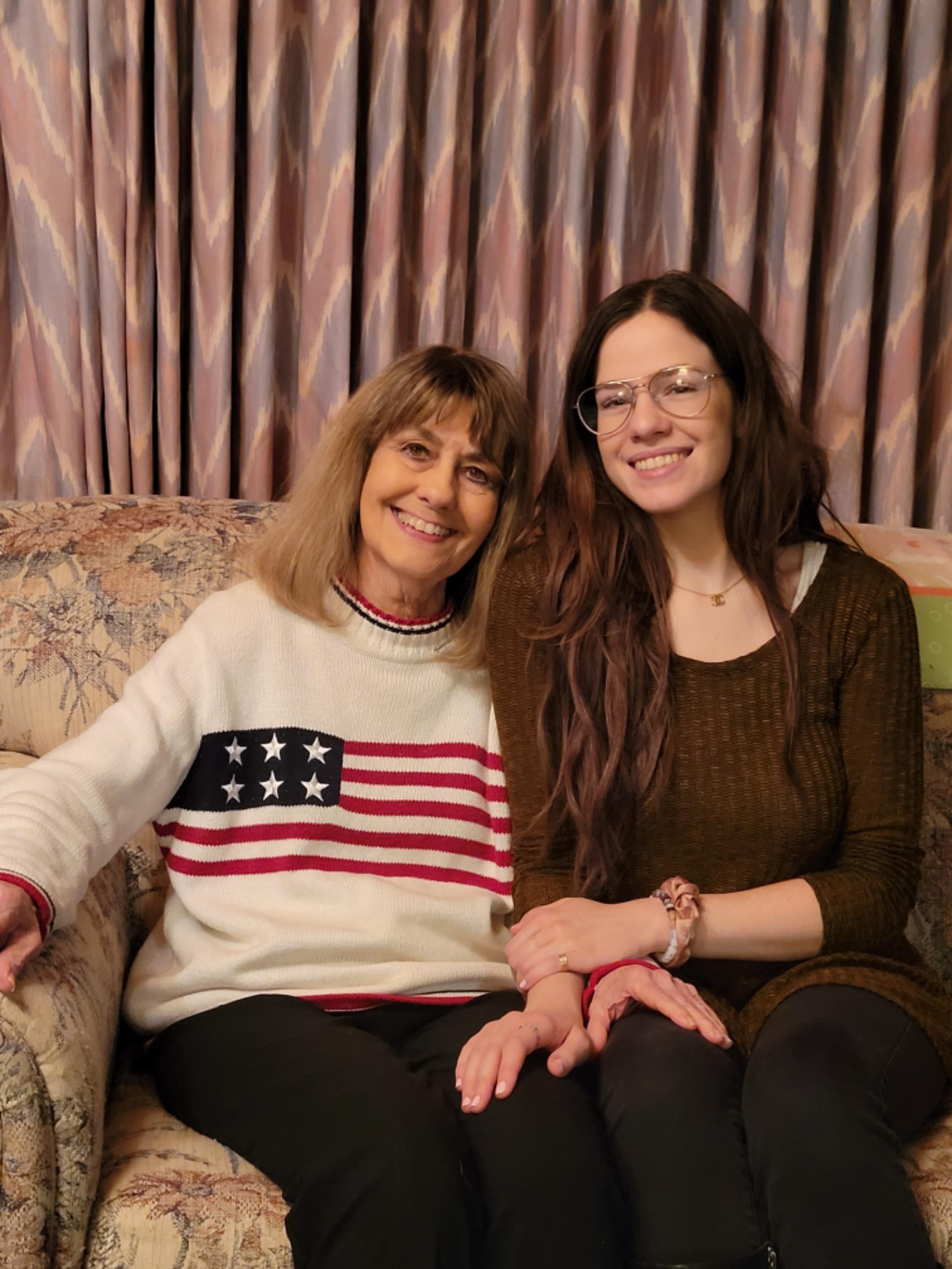 Two women sitting on a couch