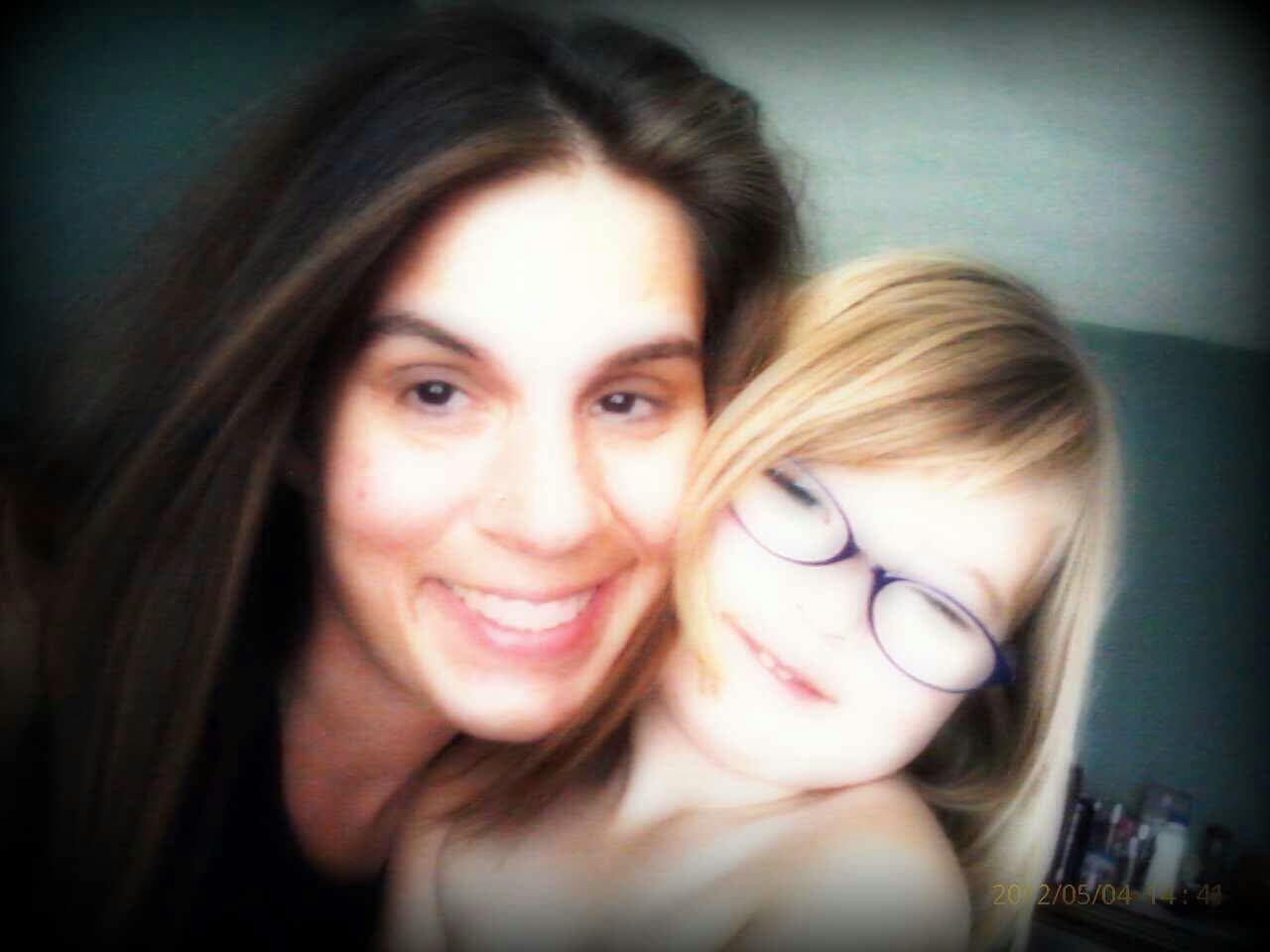 A woman and a child posing for a selfie