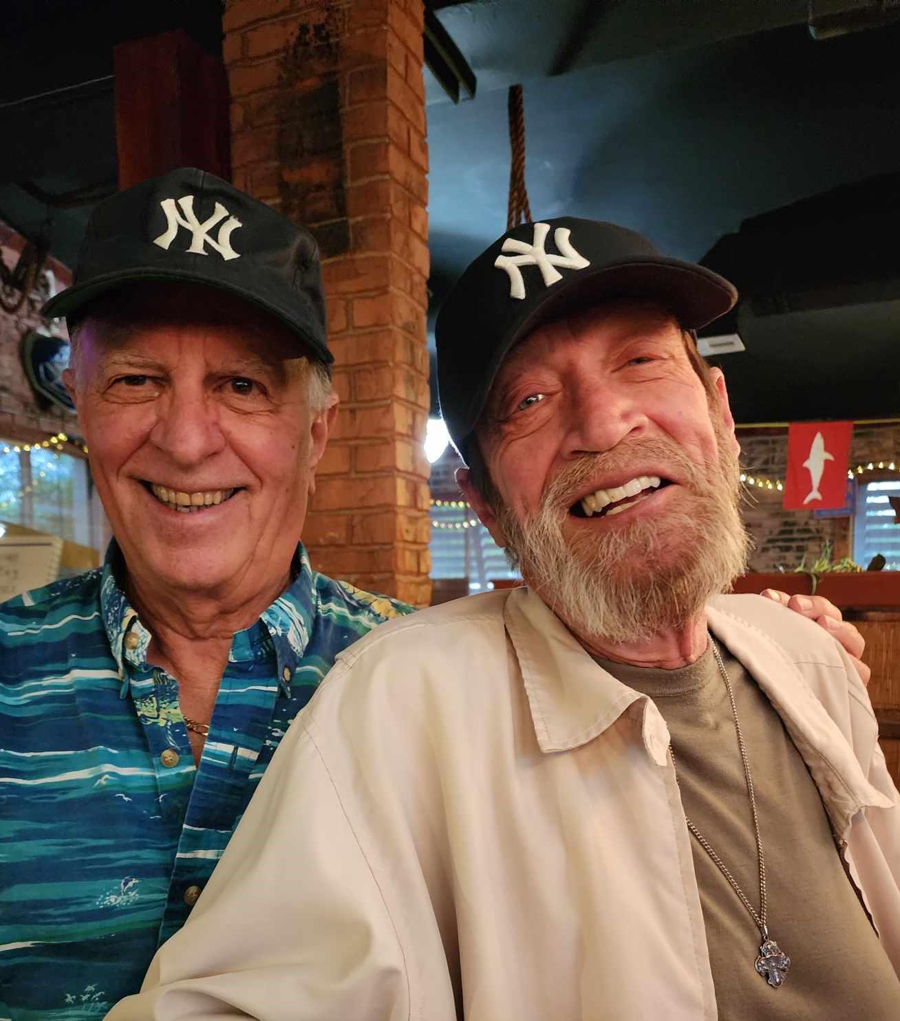 Two men wearing hats