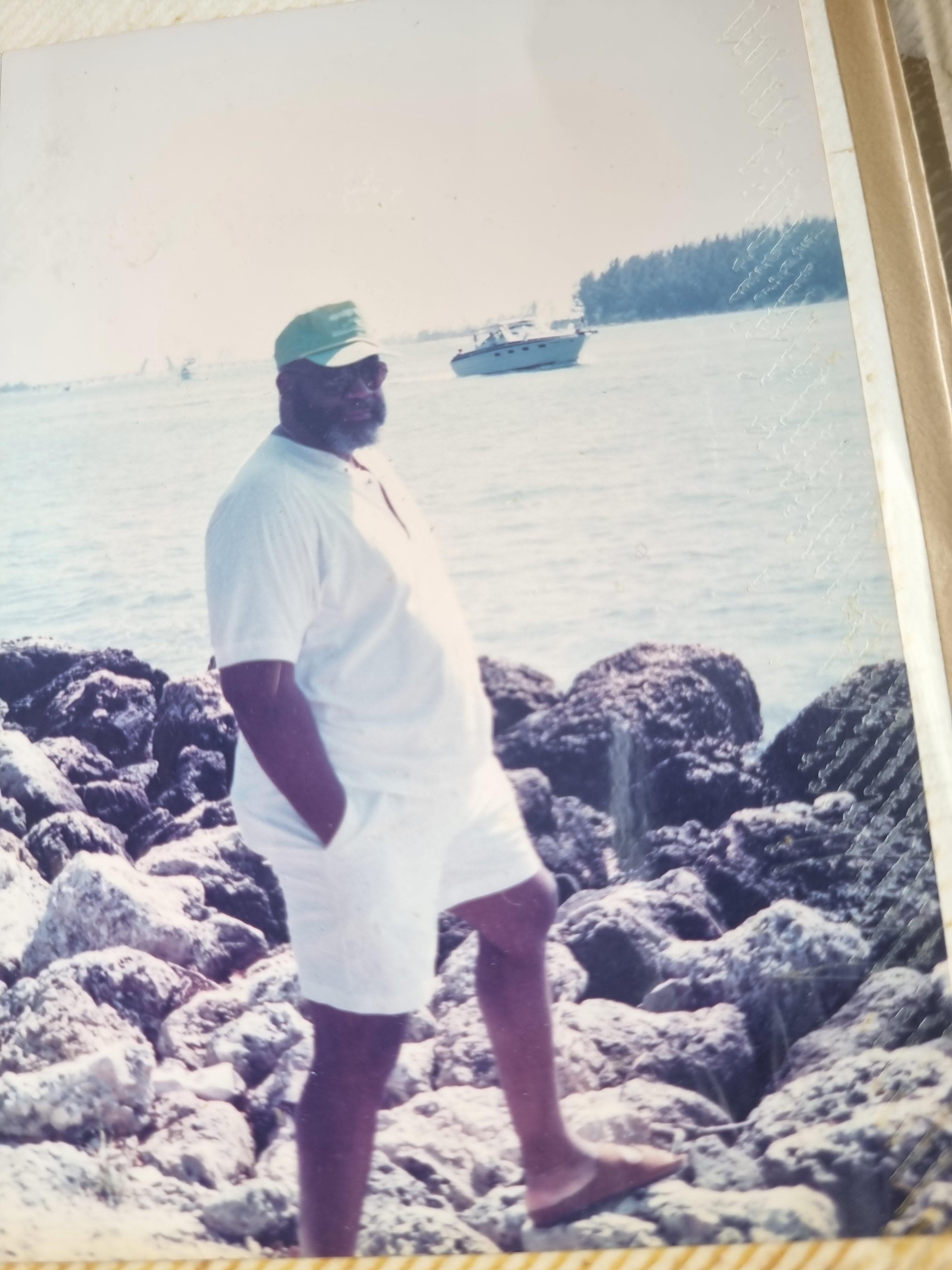 A man standing on rocks near water