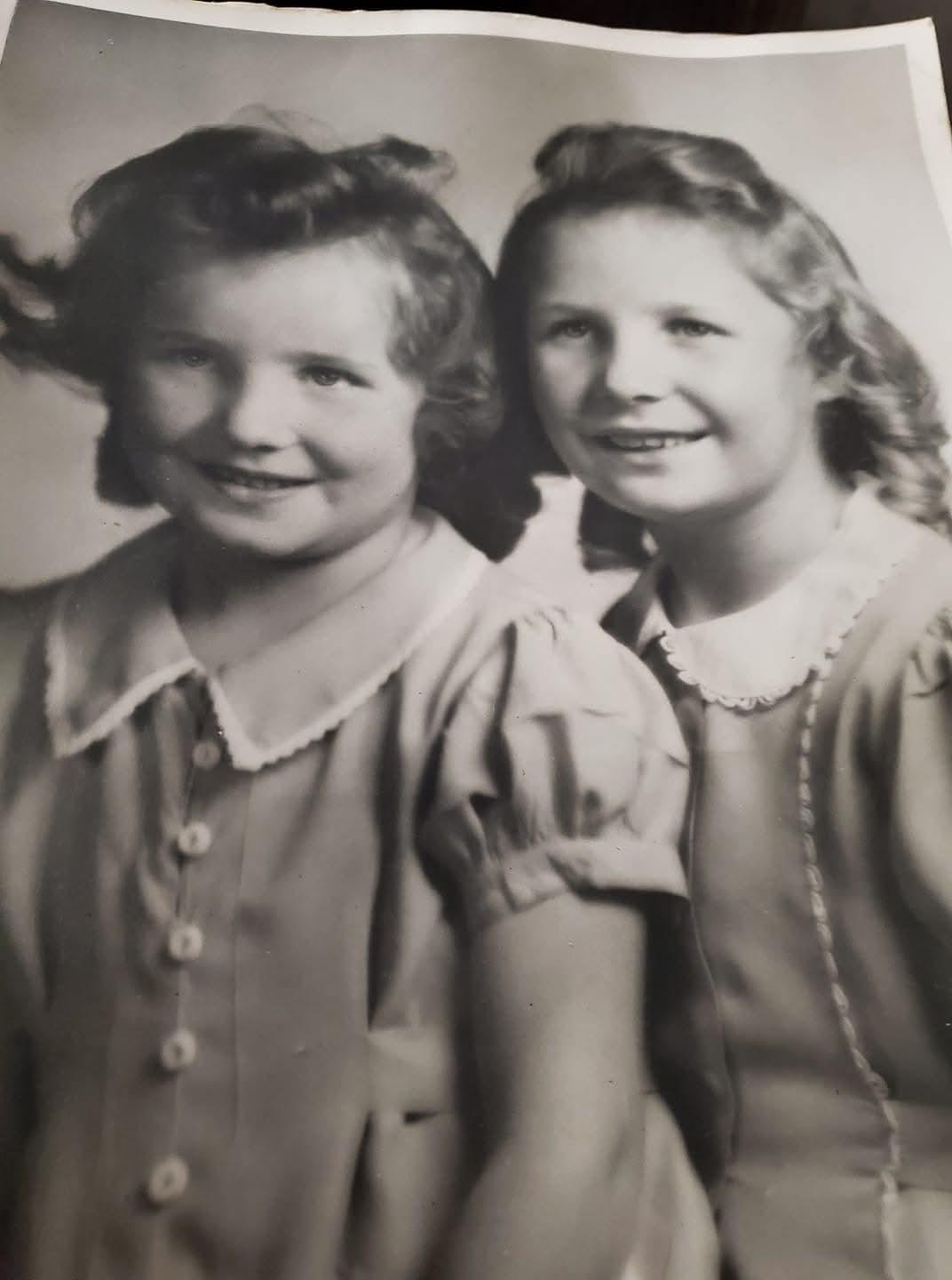 A couple of girls posing for a photo