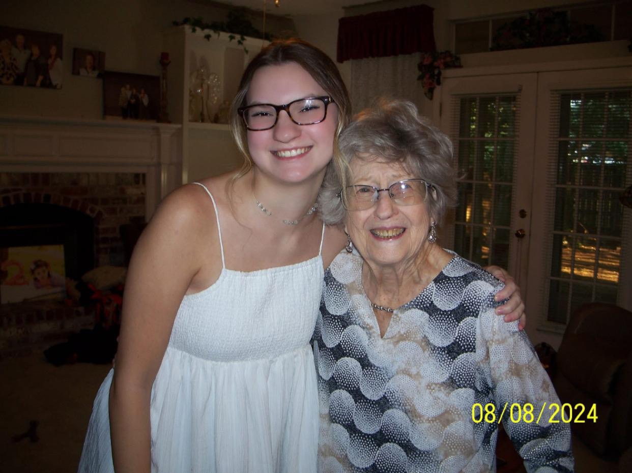 A woman and a woman posing for a picture
