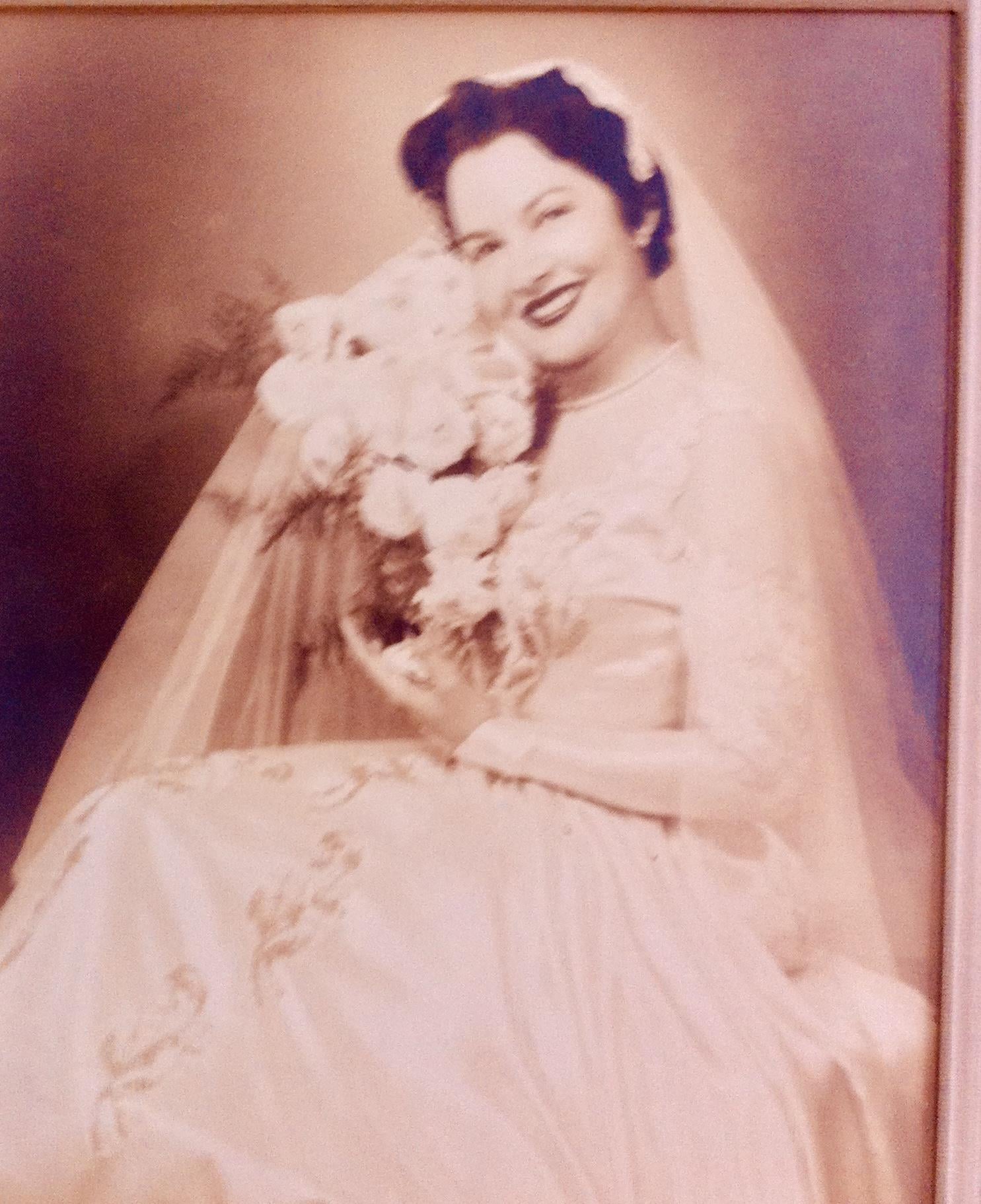 A woman in a wedding dress holding a bouquet of flowers