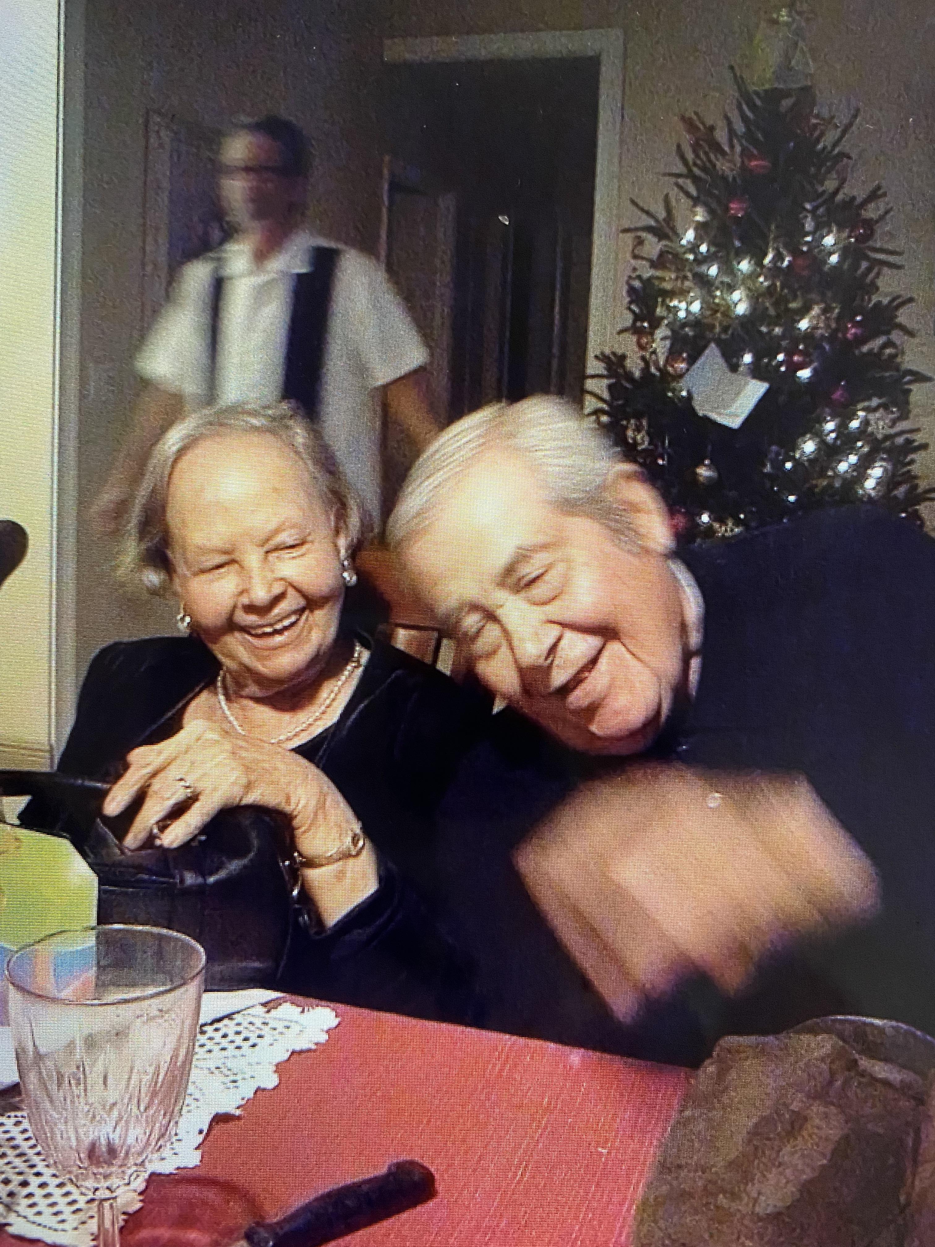 A man and woman laughing at a table
