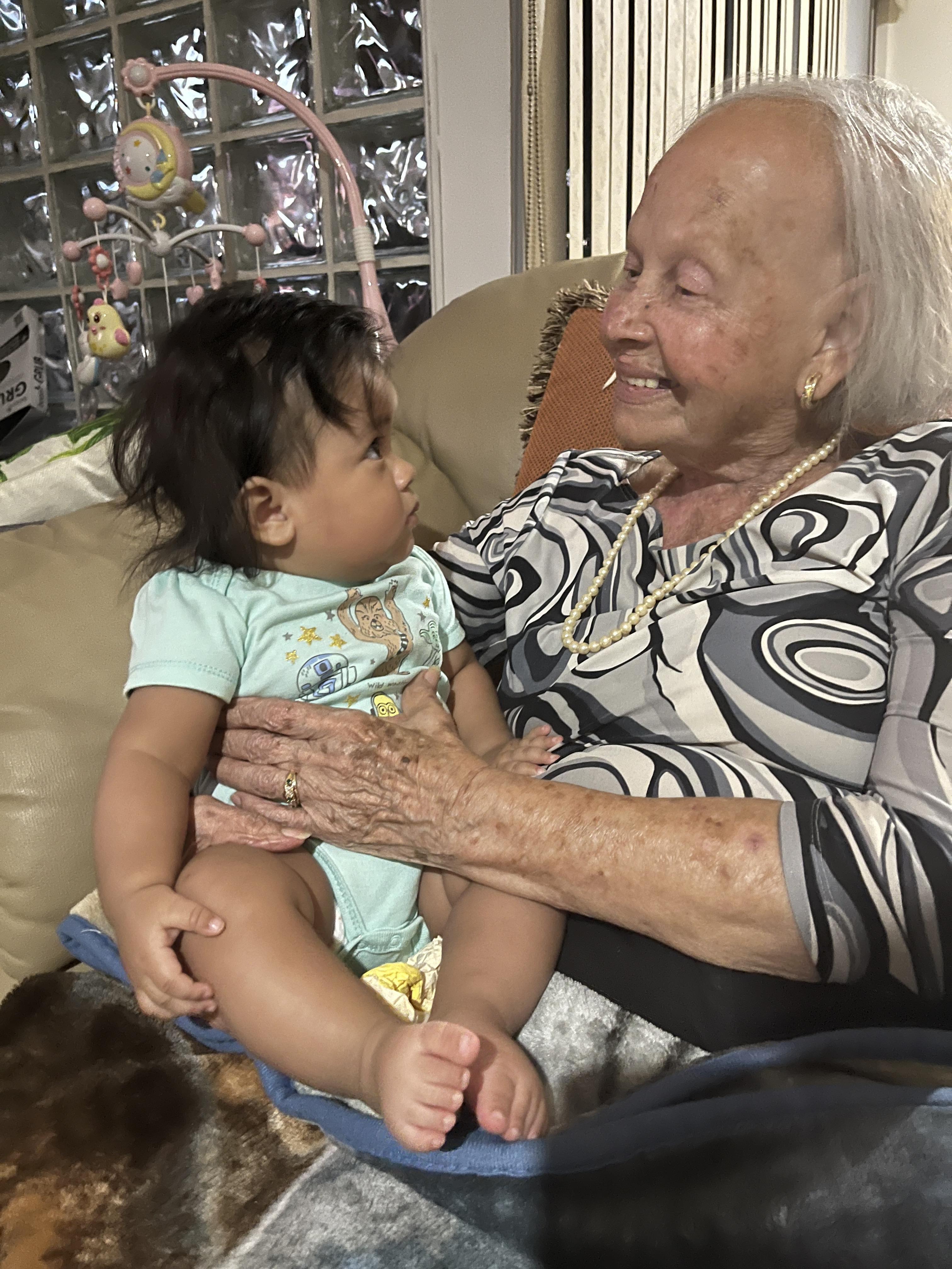 An old woman holding a baby