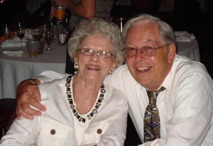 A man and woman smiling at the camera