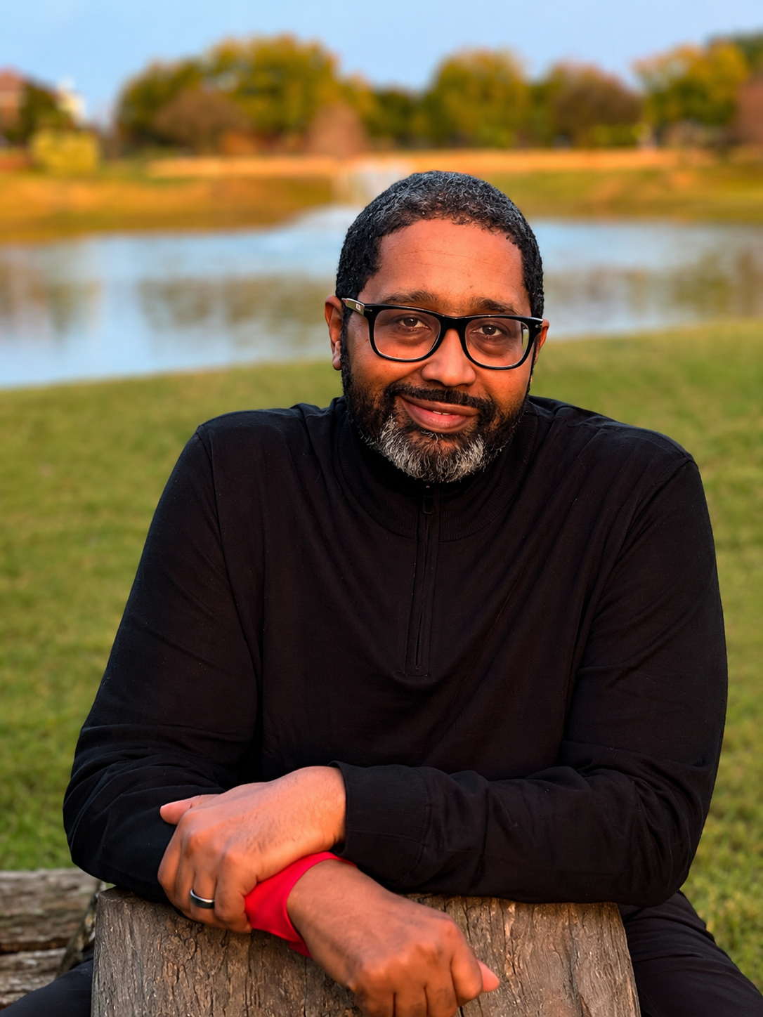 A man sitting on a bench with his arms crossed