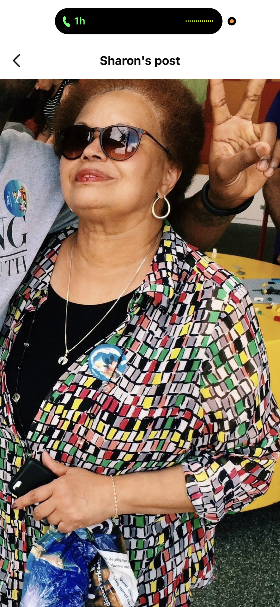 A woman wearing glasses and a colorful shirt