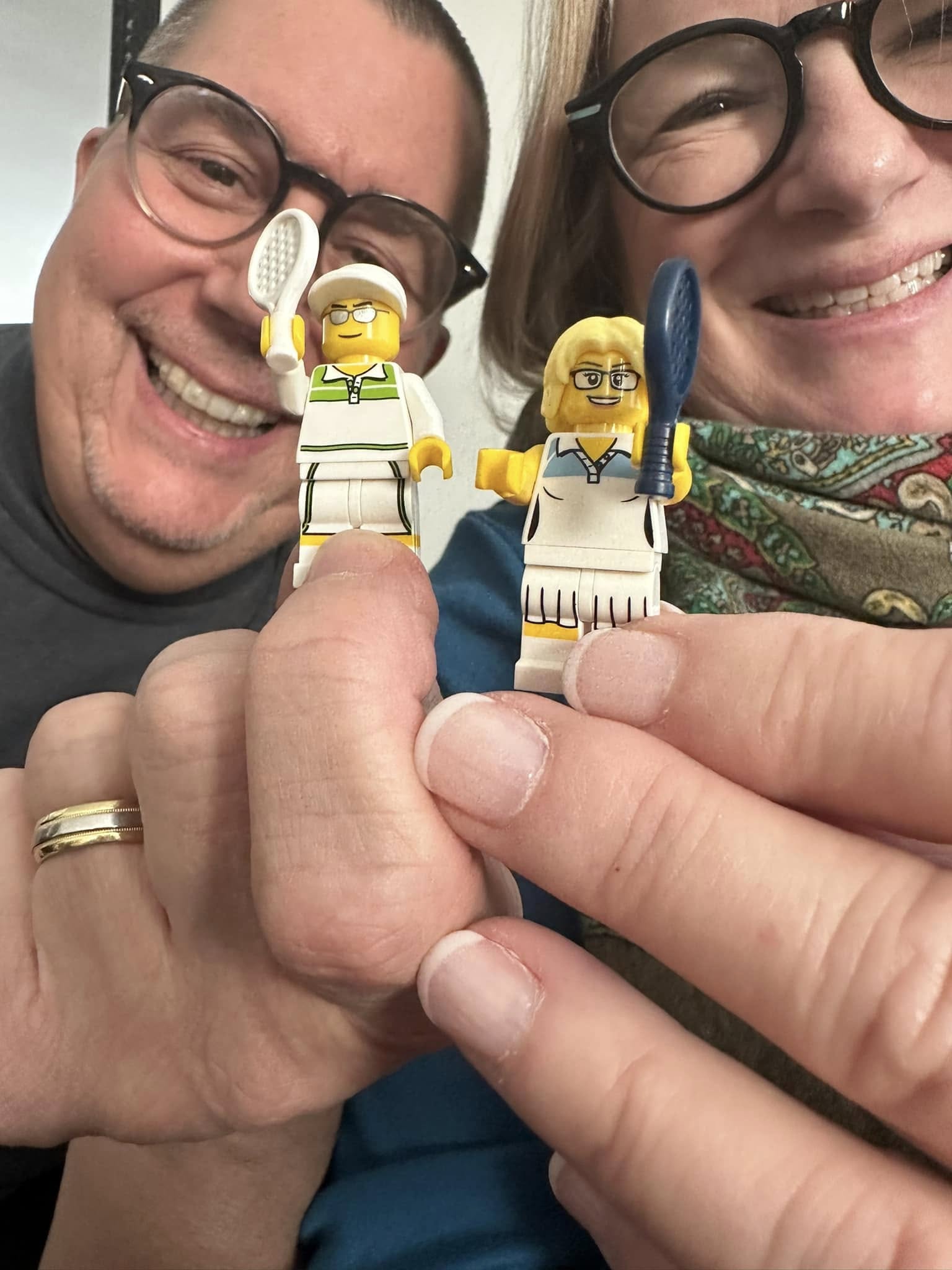 A man and woman holding small lego figures