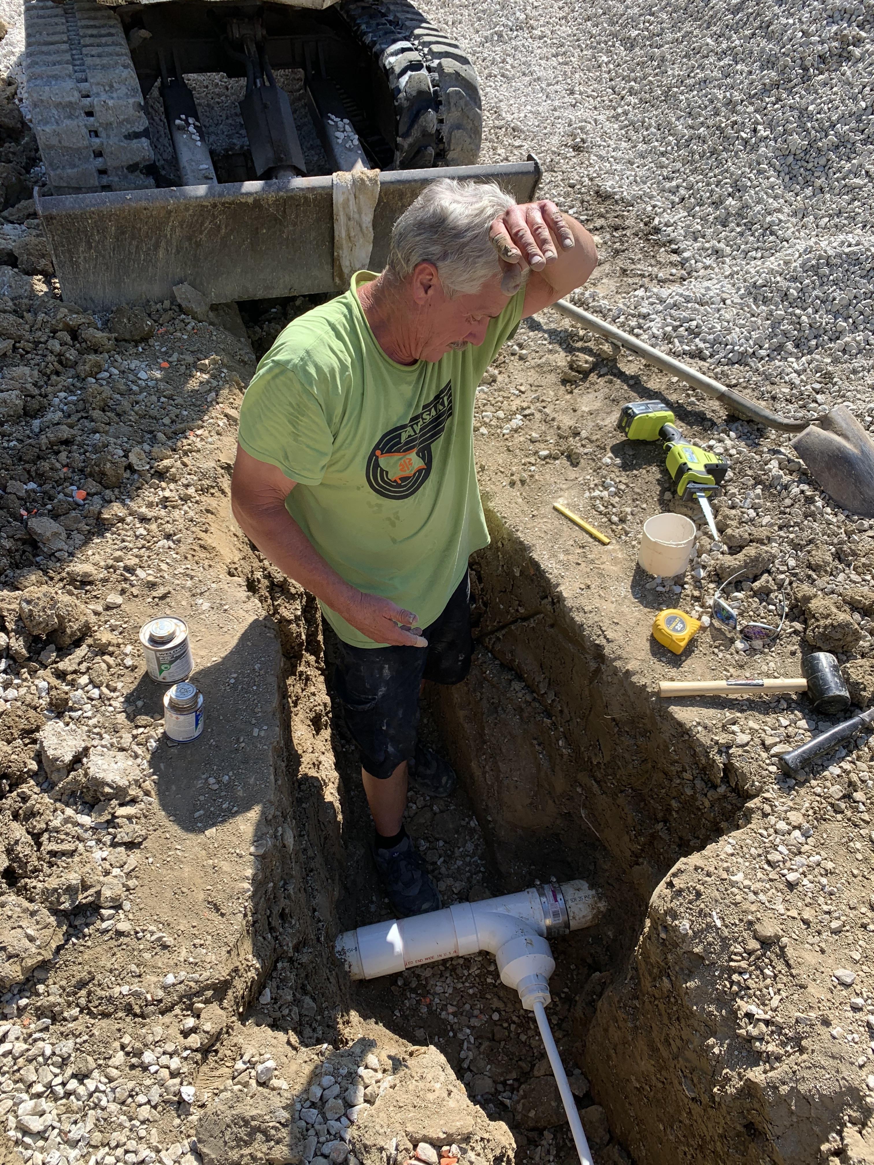 A man standing in a hole in the ground