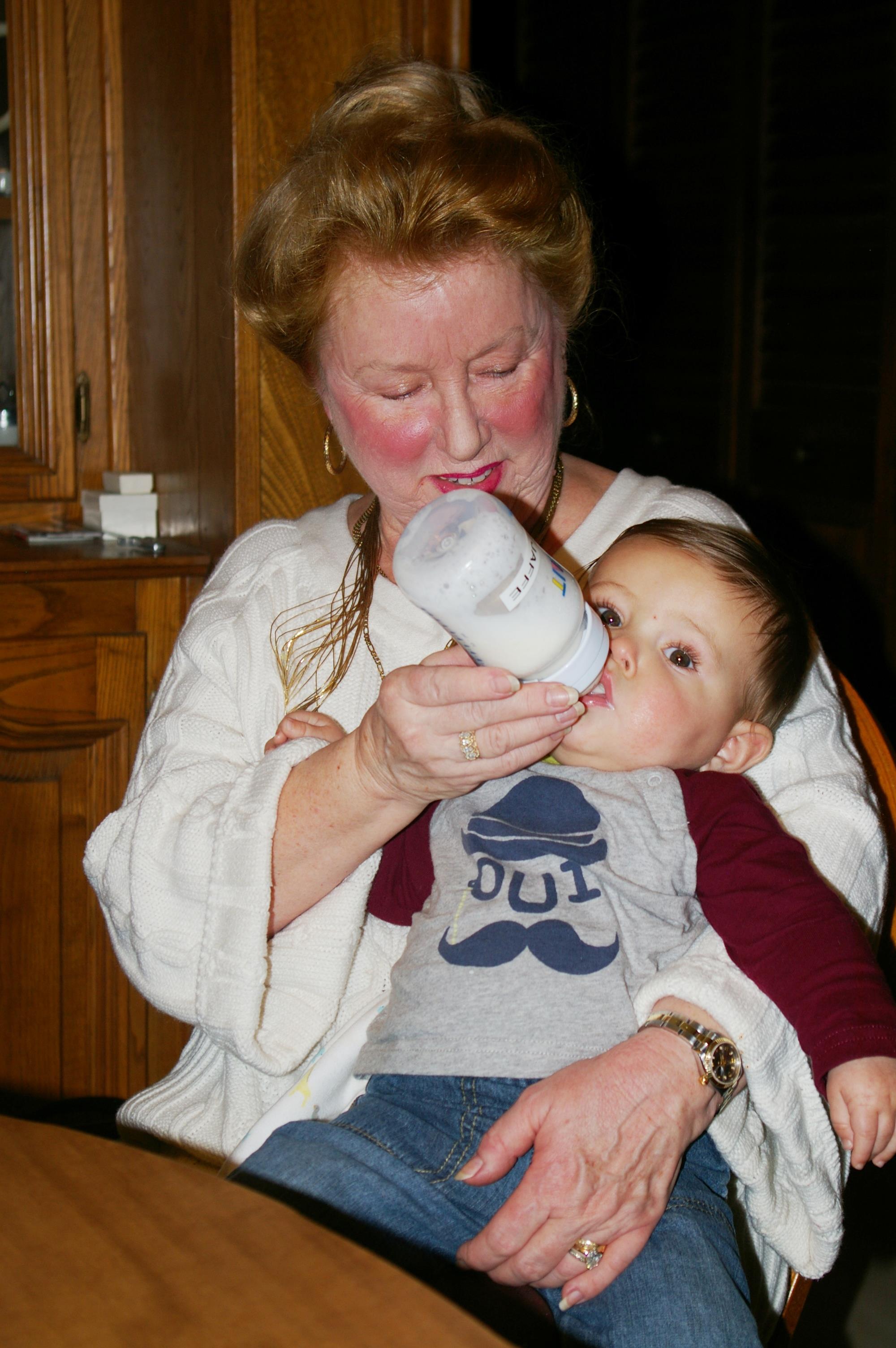 A woman feeding a baby