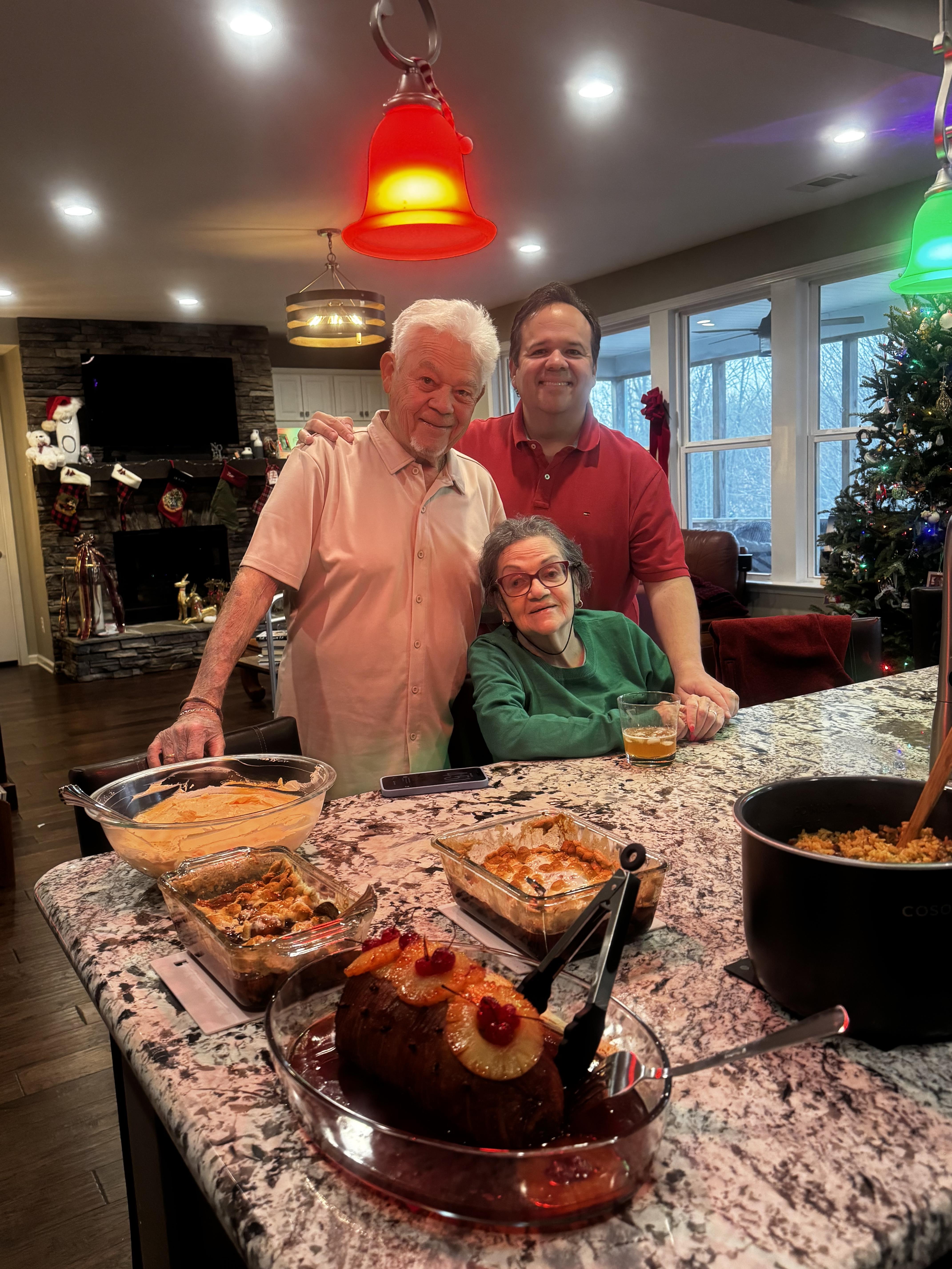A group of people standing in a kitchen