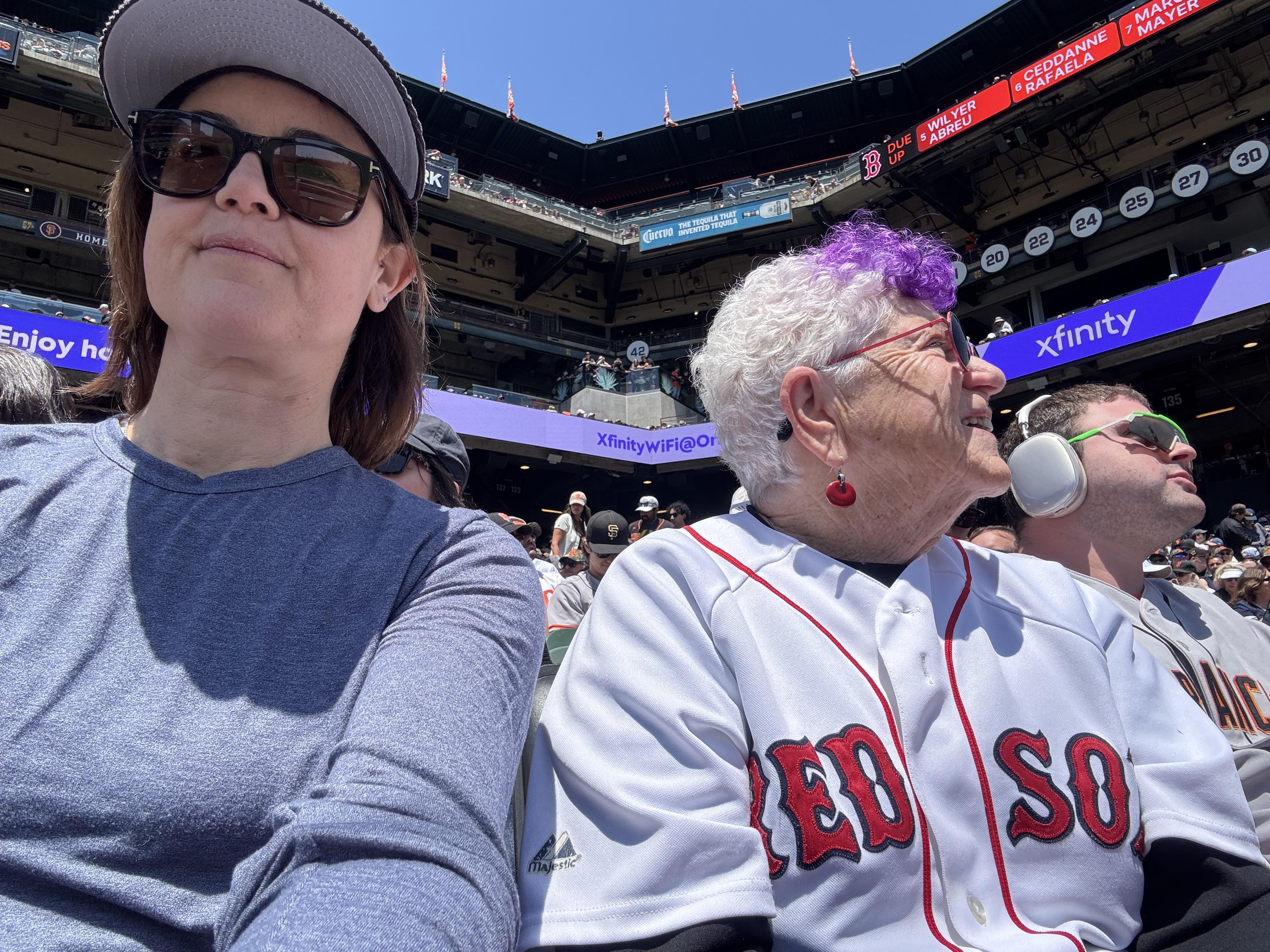 A woman and a man in a baseball stadium