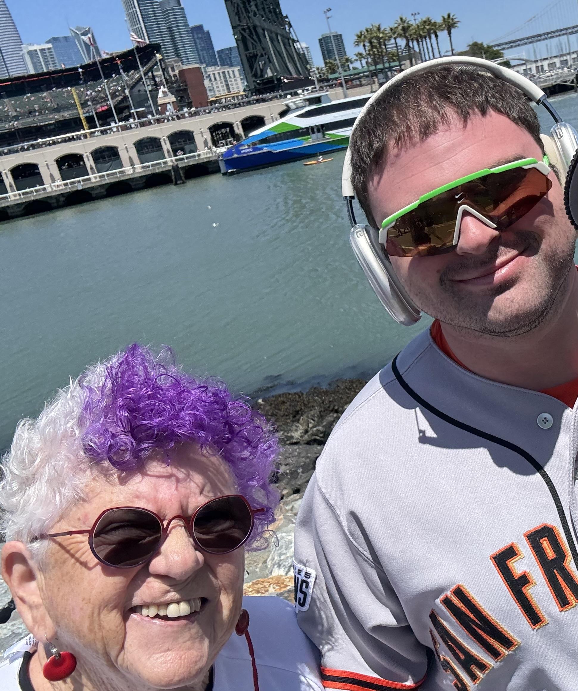 A man and woman with purple hair and sunglasses