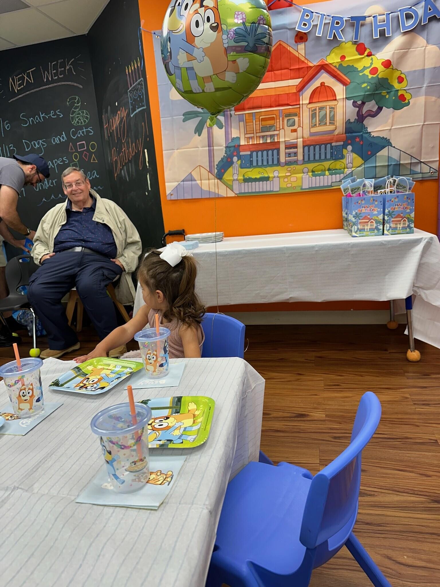 A man and a girl sitting at a table