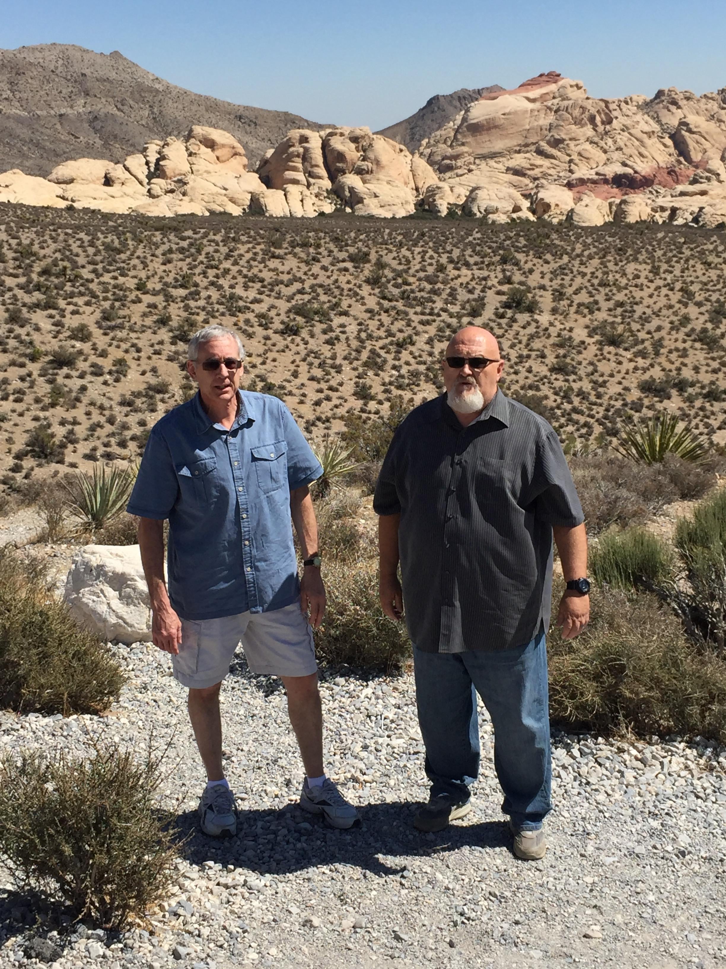 Two men standing in a desert