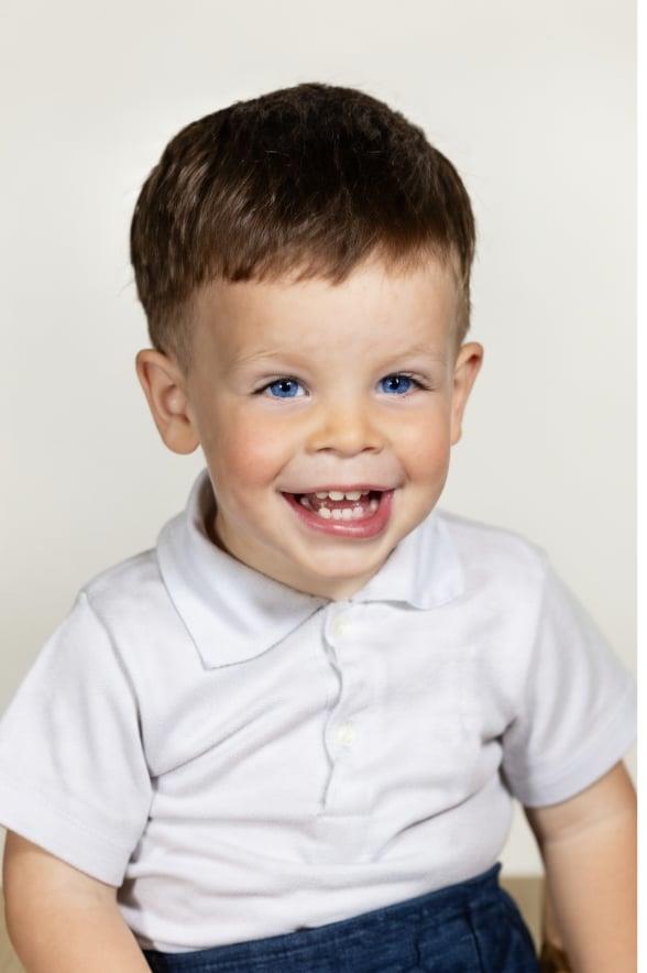 A smiling boy with blue eyes