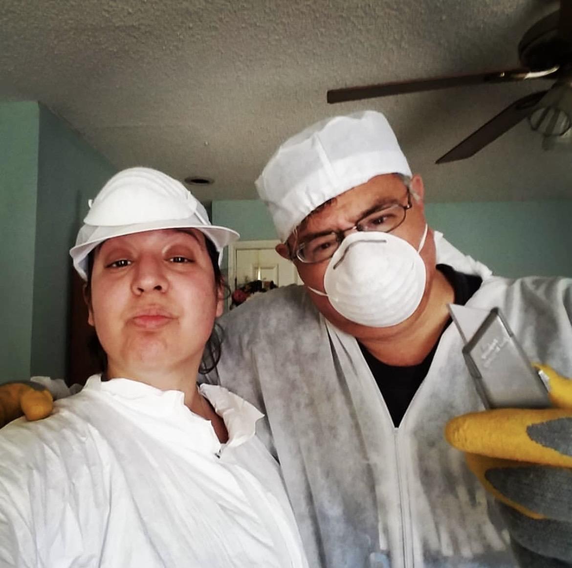 A man and woman wearing white clothes and white hats