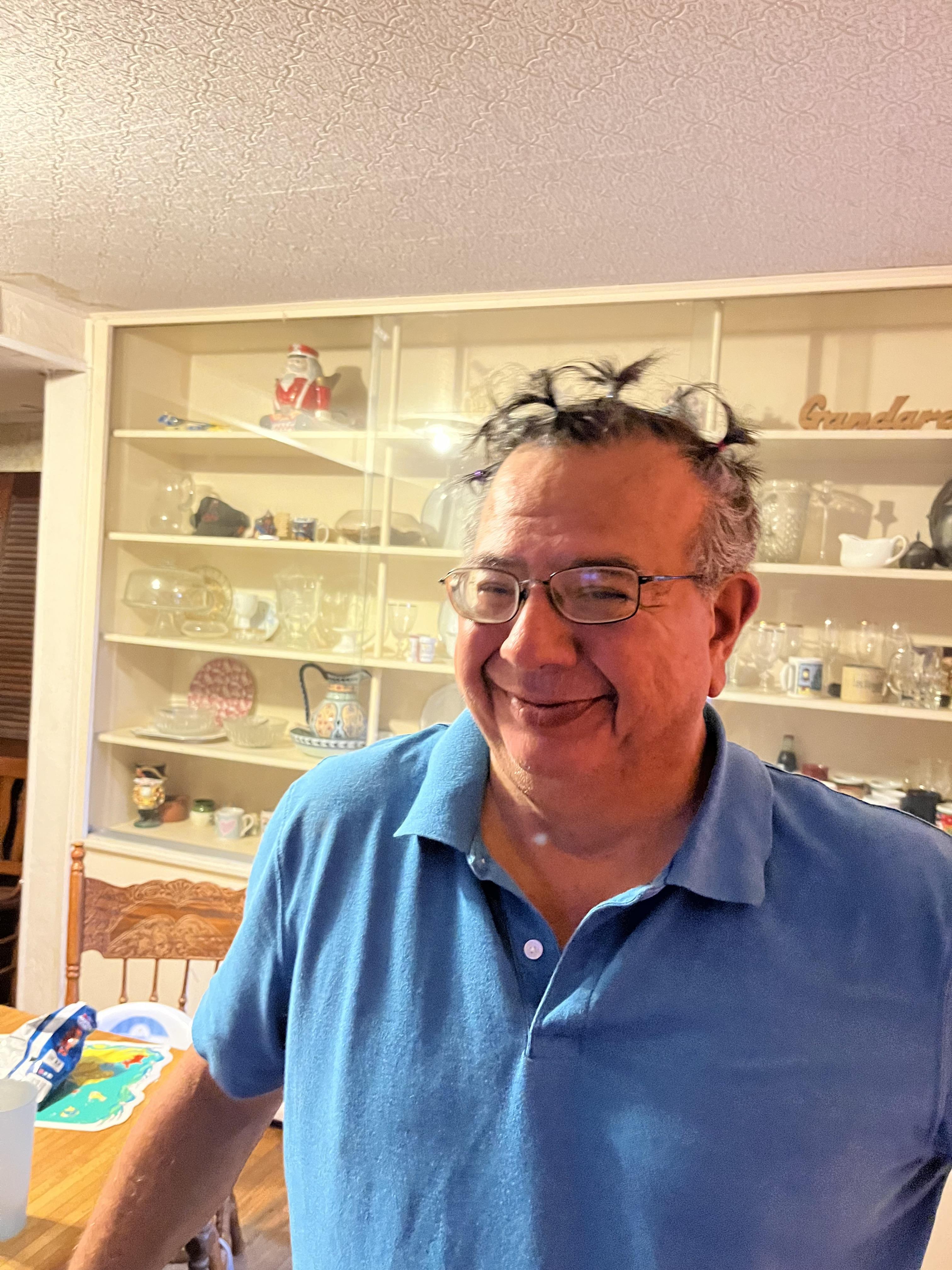 A man with glasses and a blue shirt