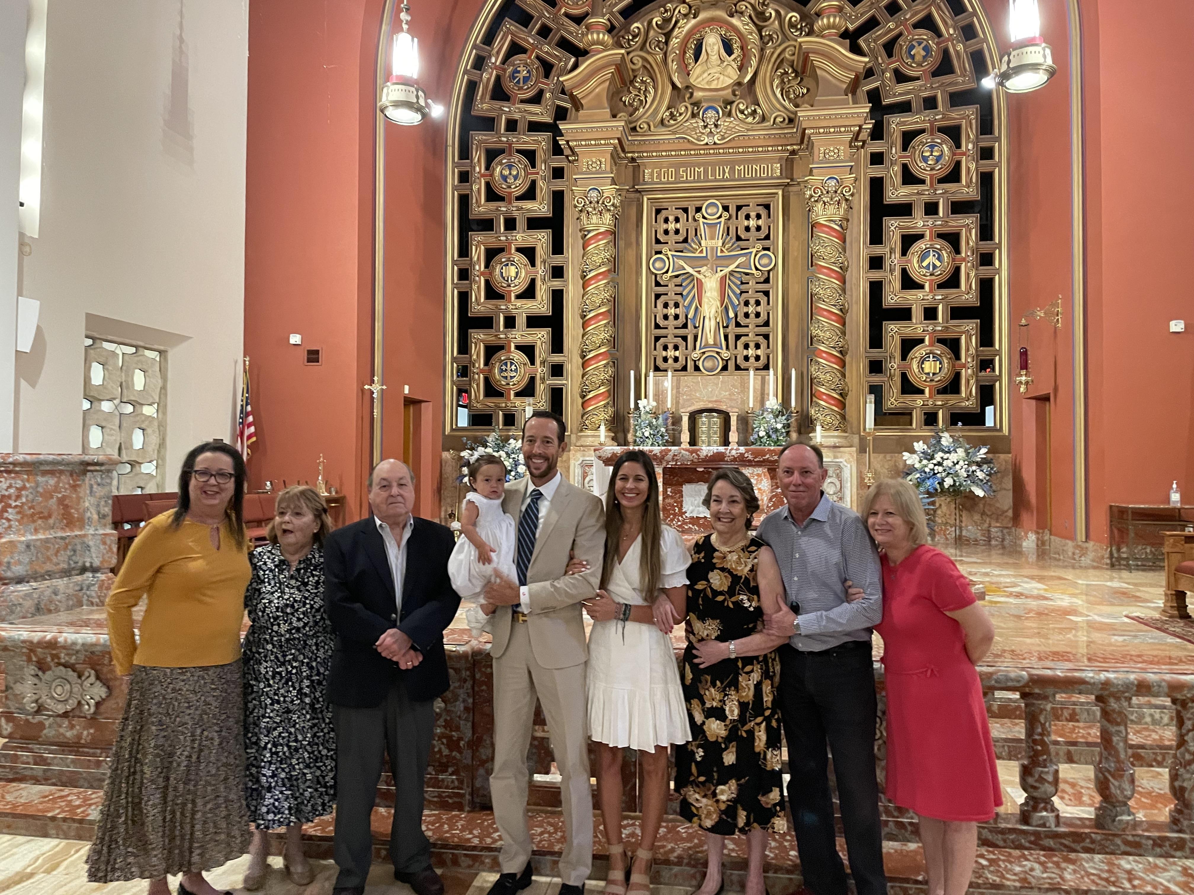 A group of people posing for a photo in a church