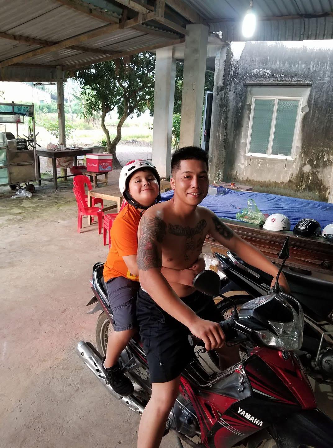 A man and boy on a motorcycle