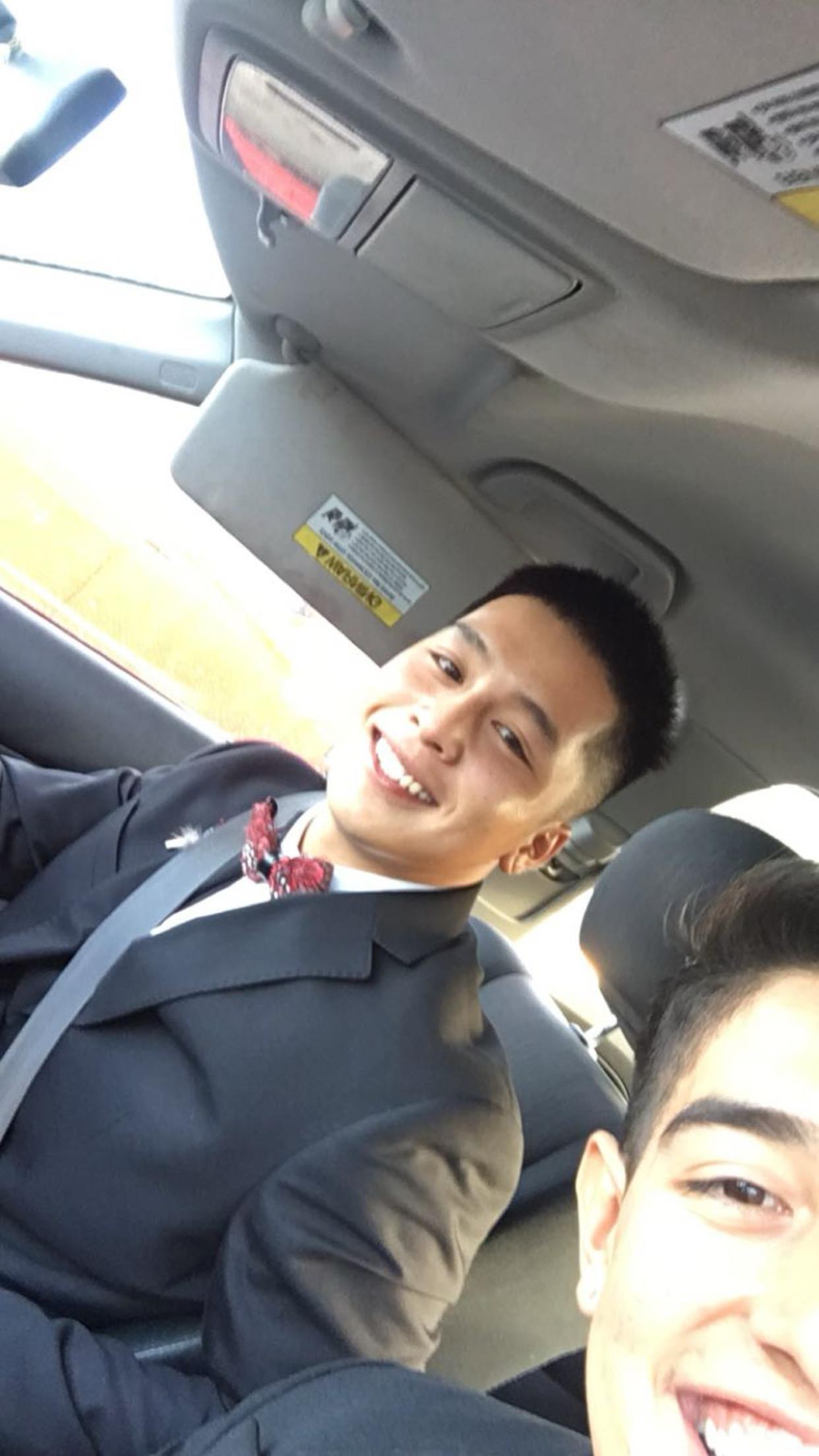 A man in a suit and tie taking a selfie